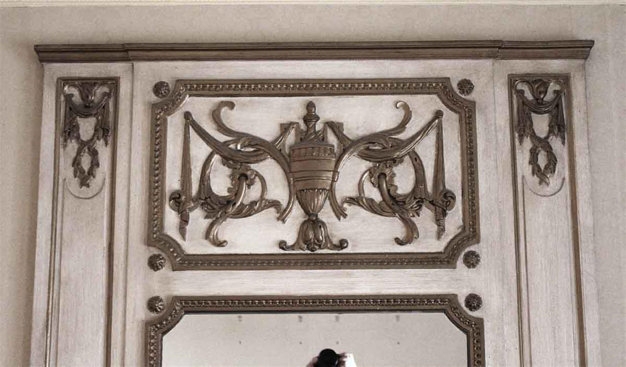 1931 decorative white wooden over mantel mirror with carved details and an urn in the top center. Original to Room 1064 of the NYC Waldorf Astoria Hotel. Waldorf Astoria authenticity card included with your purchase. This can be seen at our 333 West