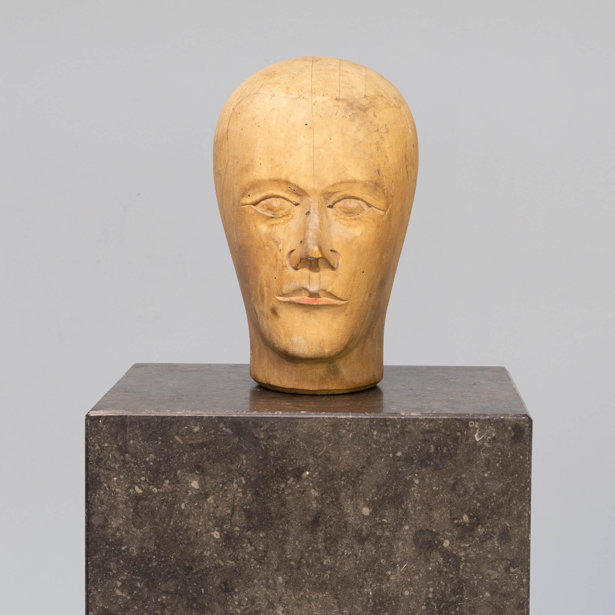 A Milliners head was designed in the 1910-1930 for fitting new hat’s on and also present the hat in stores. The heads that have been carved in wood come mostley from Germany because of the wood carve specialist that lived among the German woods. So