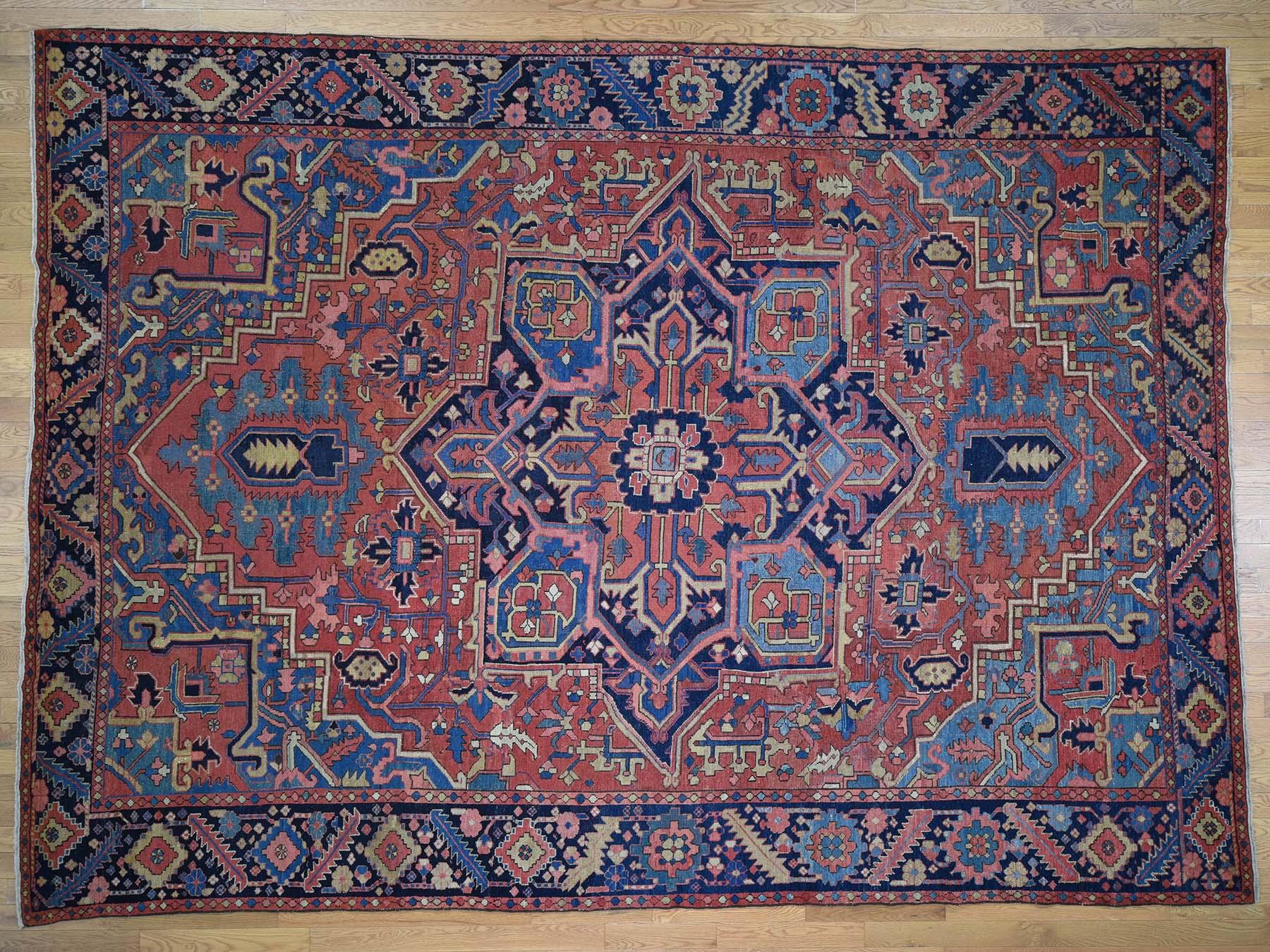This is a genuine hand knotted oriental rug. It is not hand tufted or machine made rug. Our entire inventory is made of either hand knotted or handwoven rugs.

Renovate your home style with this charming hand knotted red Heriz, is an original pure