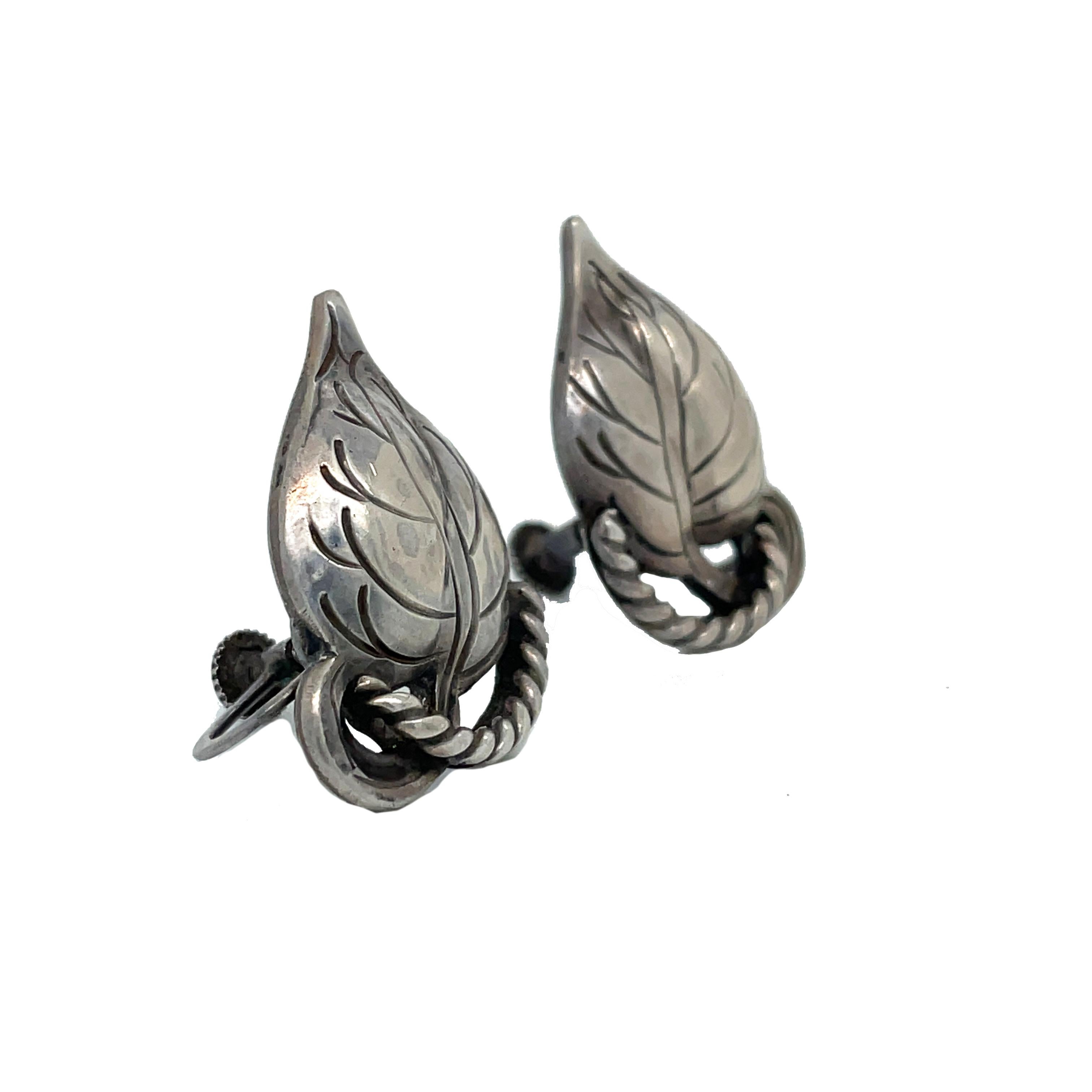 This is a lovely pair of Arts & Crafts sterling silver screw-back earrings signed by Kalo that features a leaf motif. The earrings are stamped KALO and Sterling on the back. This is a lovely pair of everyday earrings that would pair beautifully with