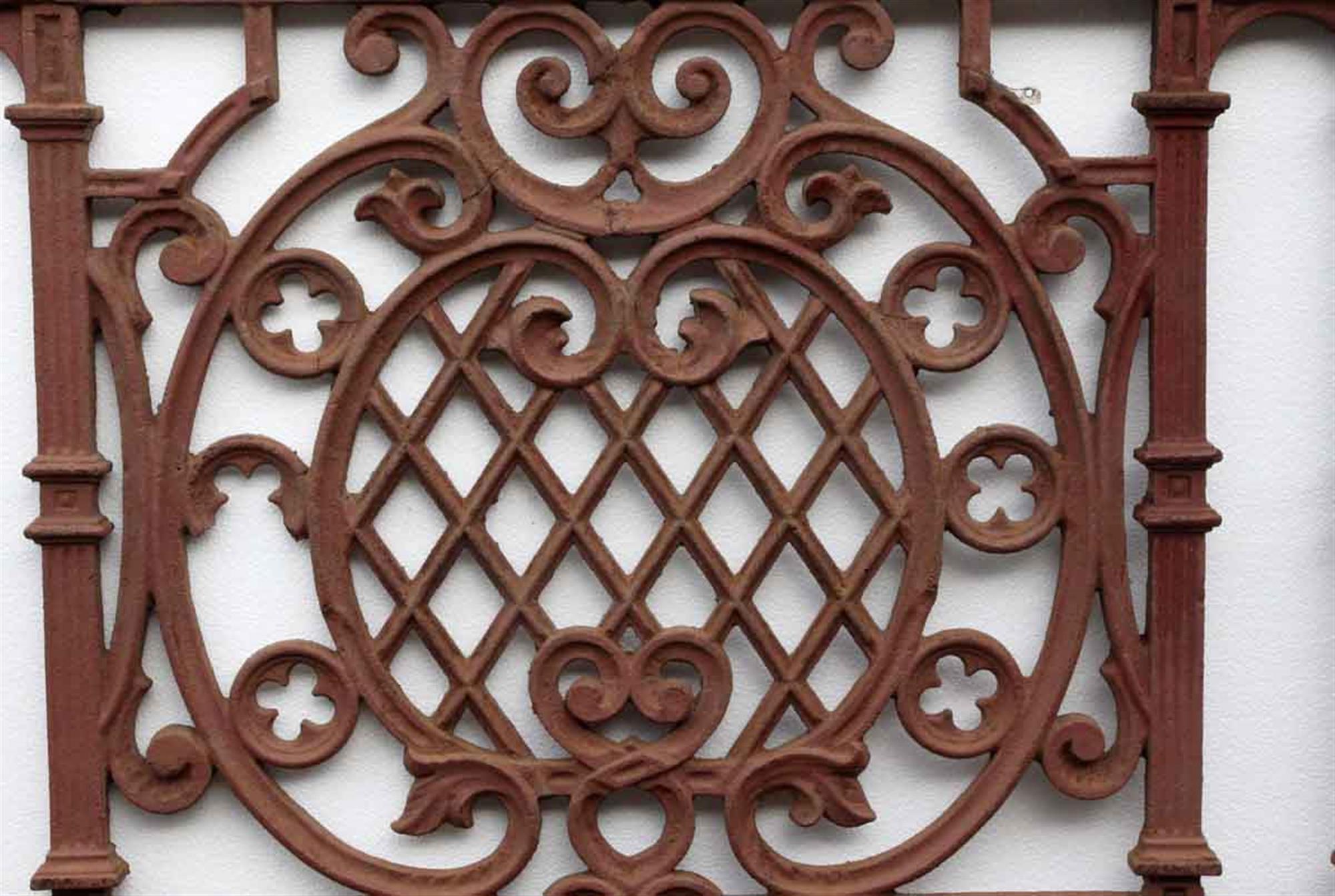 1910 cast iron balcony with a red finish and decorative quatrefoil details. This can be seen at our 400 Gilligan St location in Scranton, PA.
