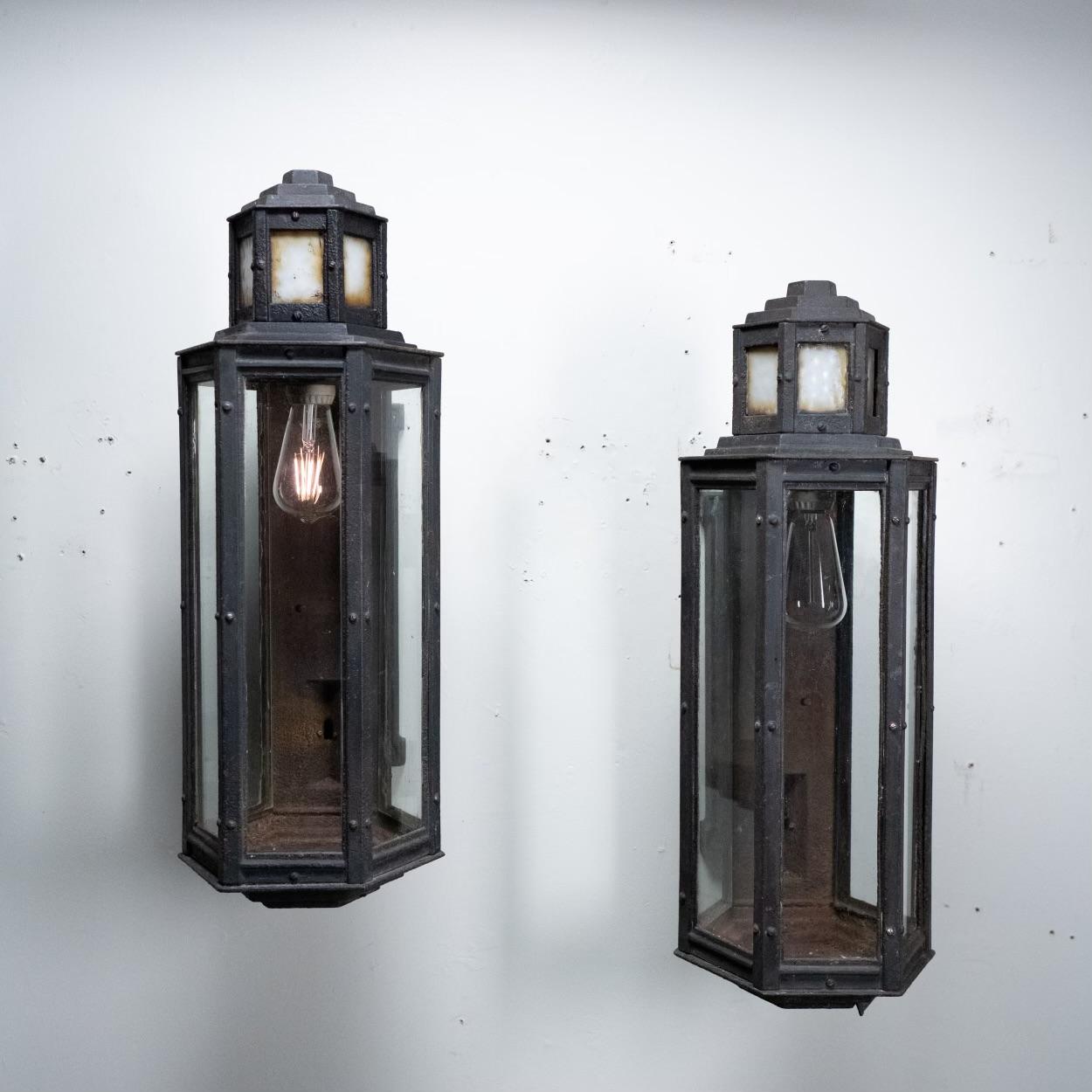 A very nice pair of cast iron exterior light fixtures salvaged from the 
Wrigley Factory building in Chicago. Very impressive unique form with Gothic details and Deco features. Lights are fully functional , show good patina , structurally sound and