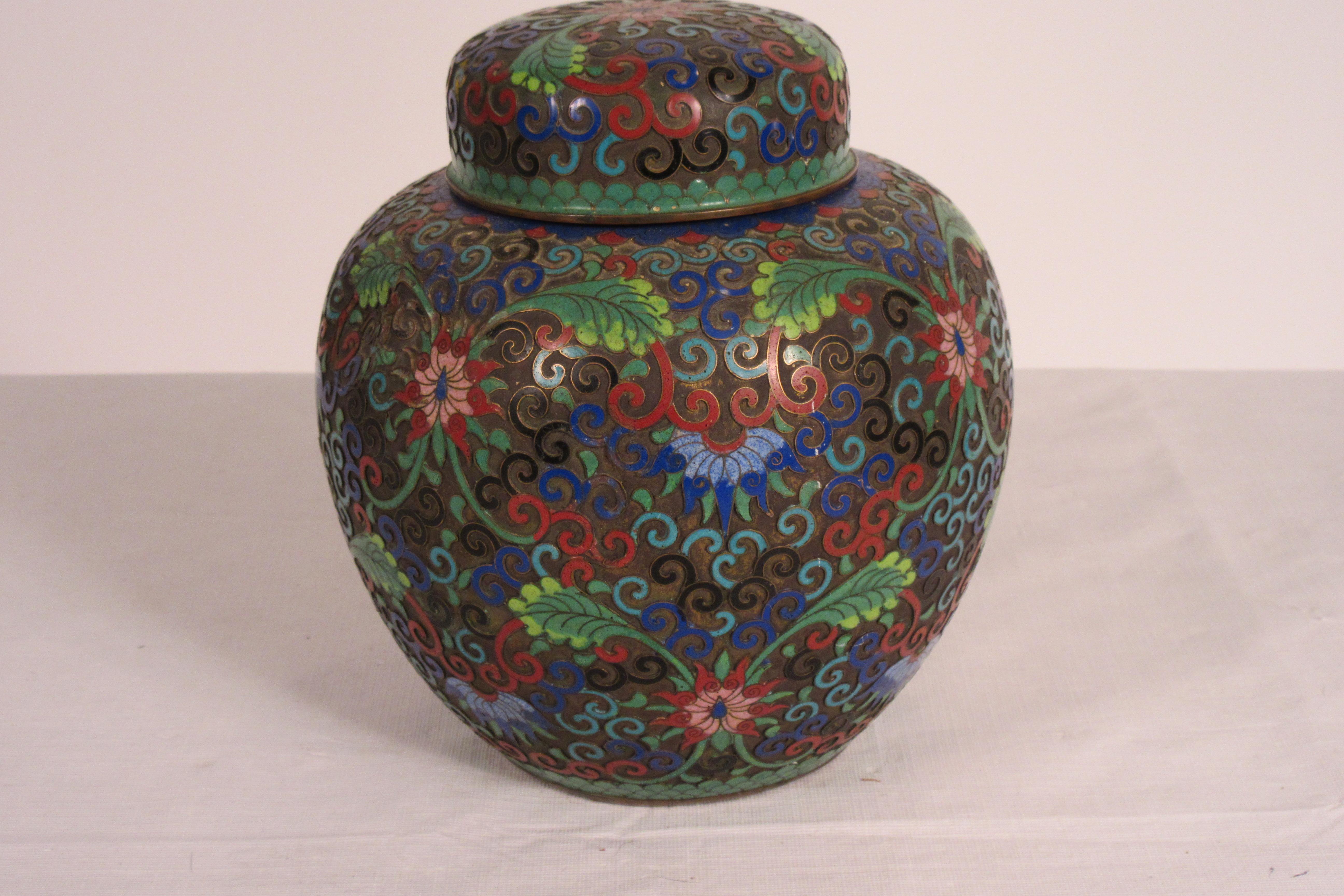 1910 cloisonné jar with lid. One dent in vase area.