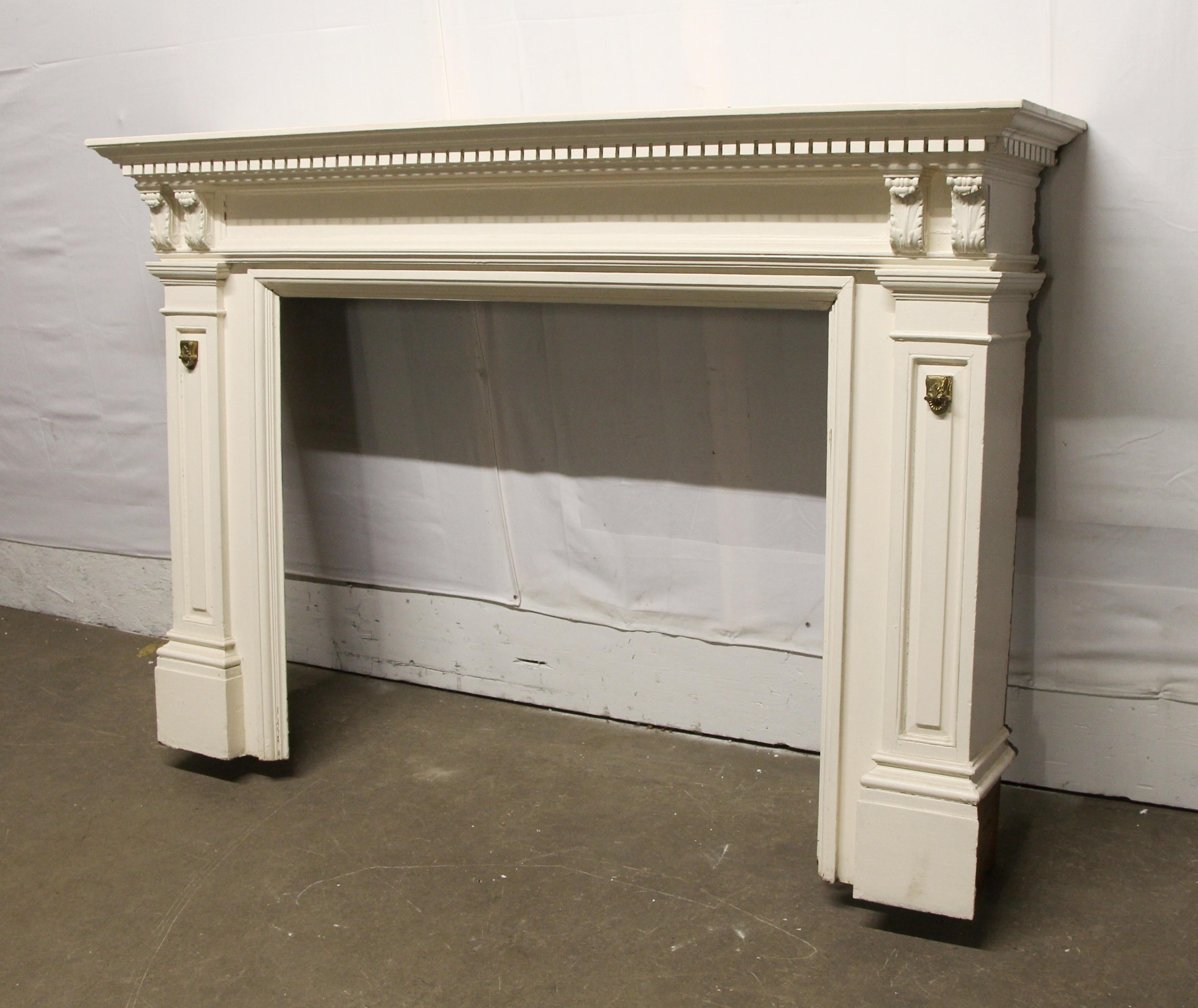 1910 carved and painted white wood mantel with brass details. There is general wear from age and use, along with minor damages. Please see photos. This can be seen at our 400 Gilligan St location in Scranton, PA.