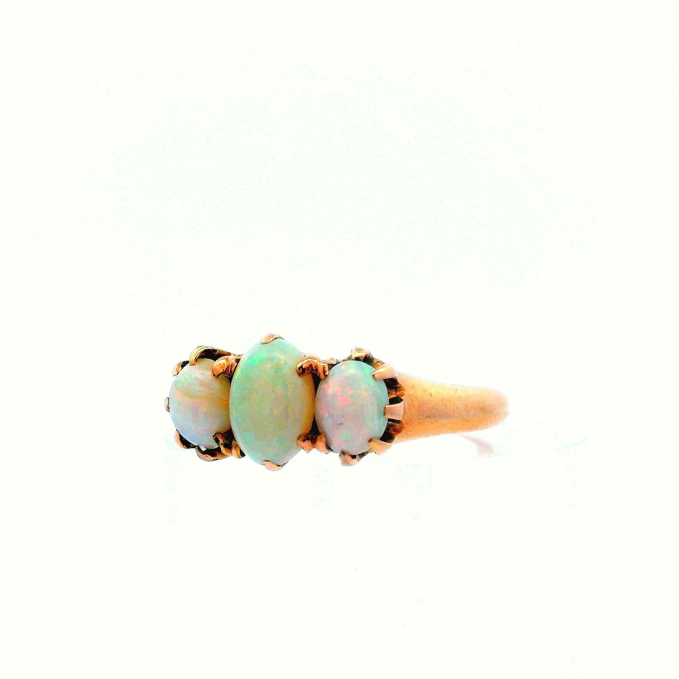 This is a gorgeous, 1910 Edwardian, 14k yellow gold and opal ring. This ring is very unique, featuring three cabochon cut opals with excellent body color. The wide range of body color provides a beautiful layer of sparkle, and also allows for this