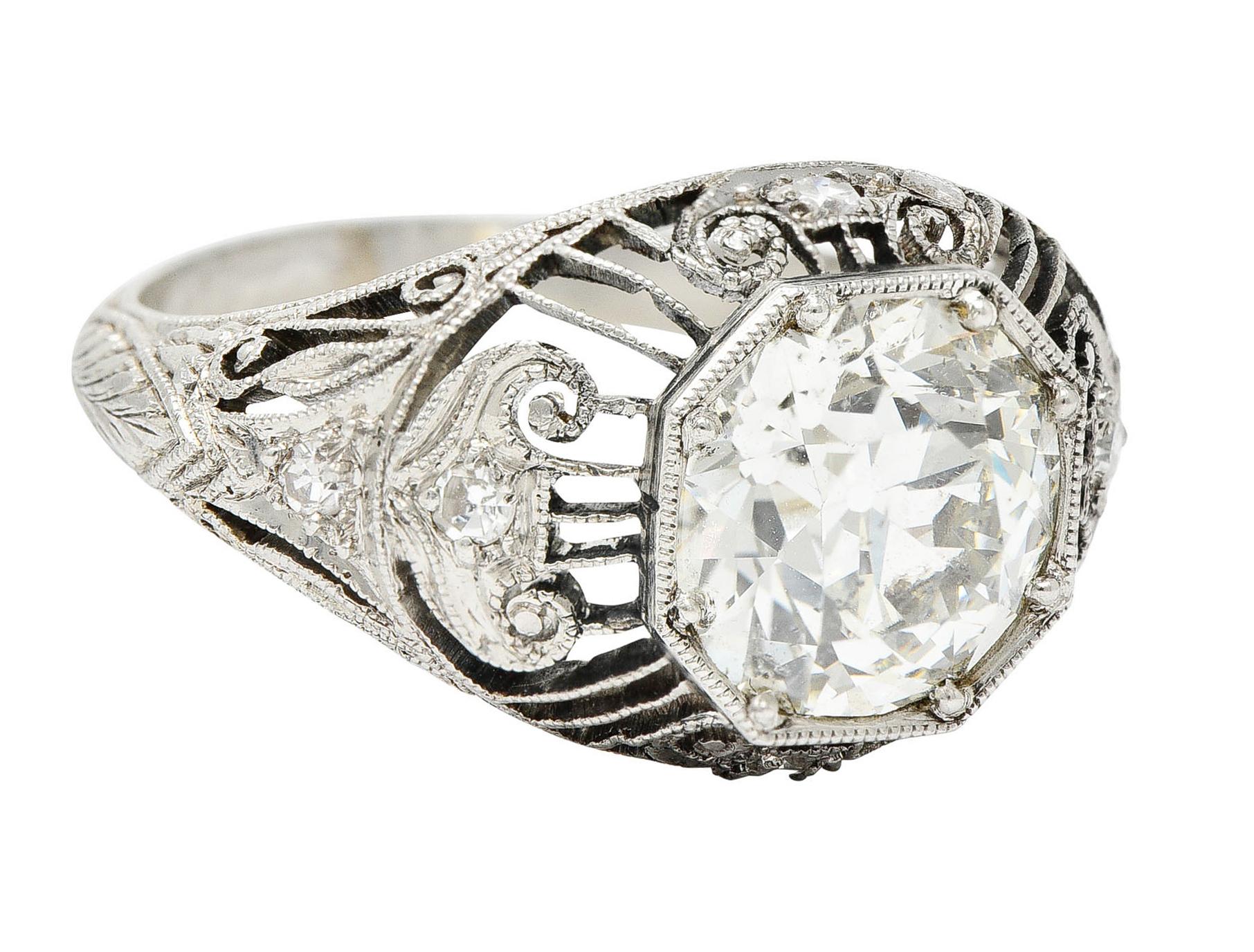 Bombè ring centers an old European cut diamond weighing approximately 2.30 carats - K/L color with I-1 clarity

Set low in an octagonal head surrounded by a striated gallery with scrolled volute stations

Accented by single cut diamonds weighing in