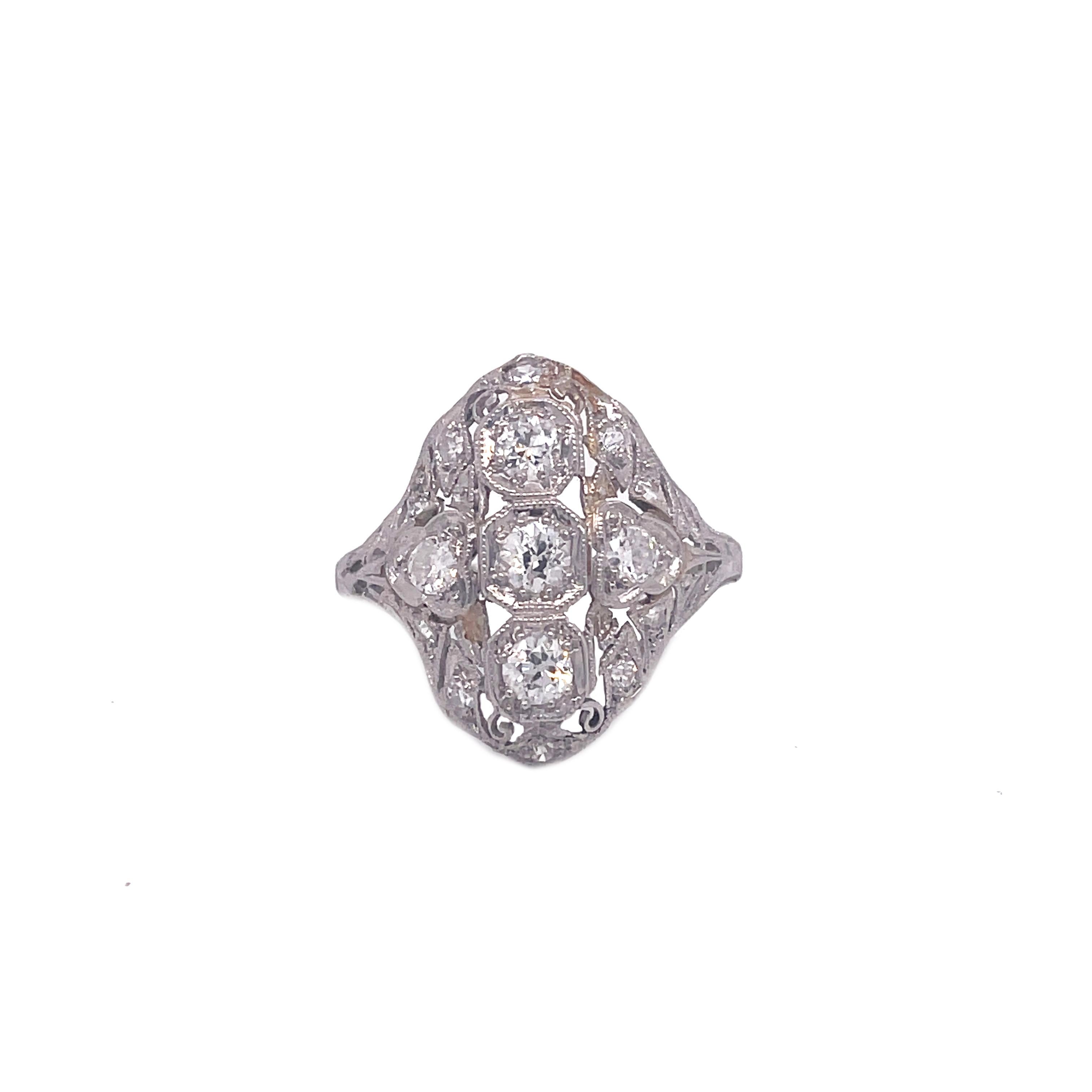 This 1910 Edwardian ring is the definition of dreamy, from the dazzling old mine-cut diamonds to the intricate platinum filigree, this ring is breathtaking. The ring is adorned with 5 brilliant old mine-cut diamonds that sparkle from tables away.