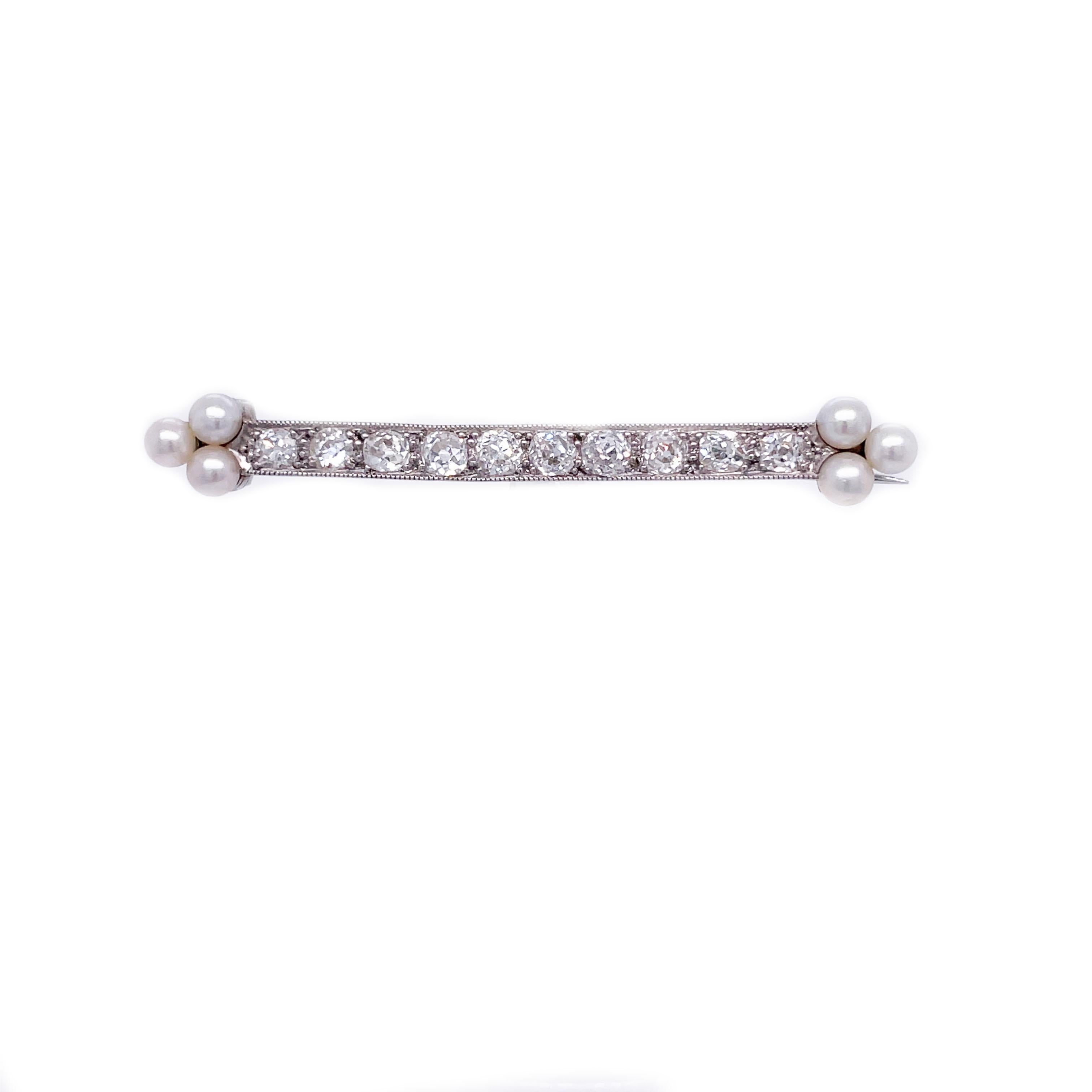 This is a dreamy brooch dating back to the Edwardian period crafted in Platinum that showcases bright white pearls and diamonds! This is a stunning bar pin that is classic and timeless. This lovely pin is adorned with 10 gleaming old mine-cut