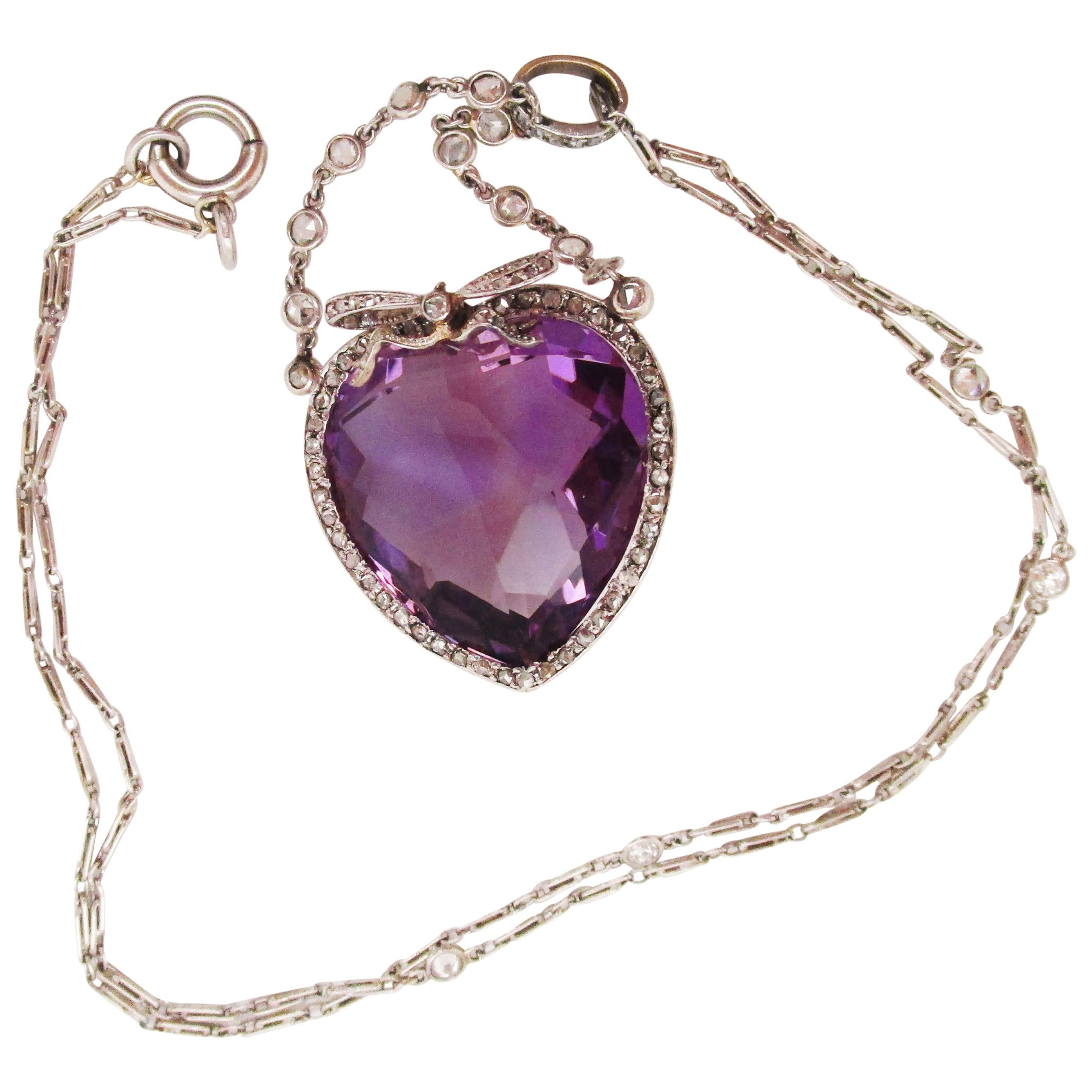 This gorgeous Edwardian necklace is from 1910 and is unlike anything you will see with its wonderful combination of platinum over yellow gold, rich purple amethyst, and brilliant white diamonds! The necklace features a platinum chain that boasts