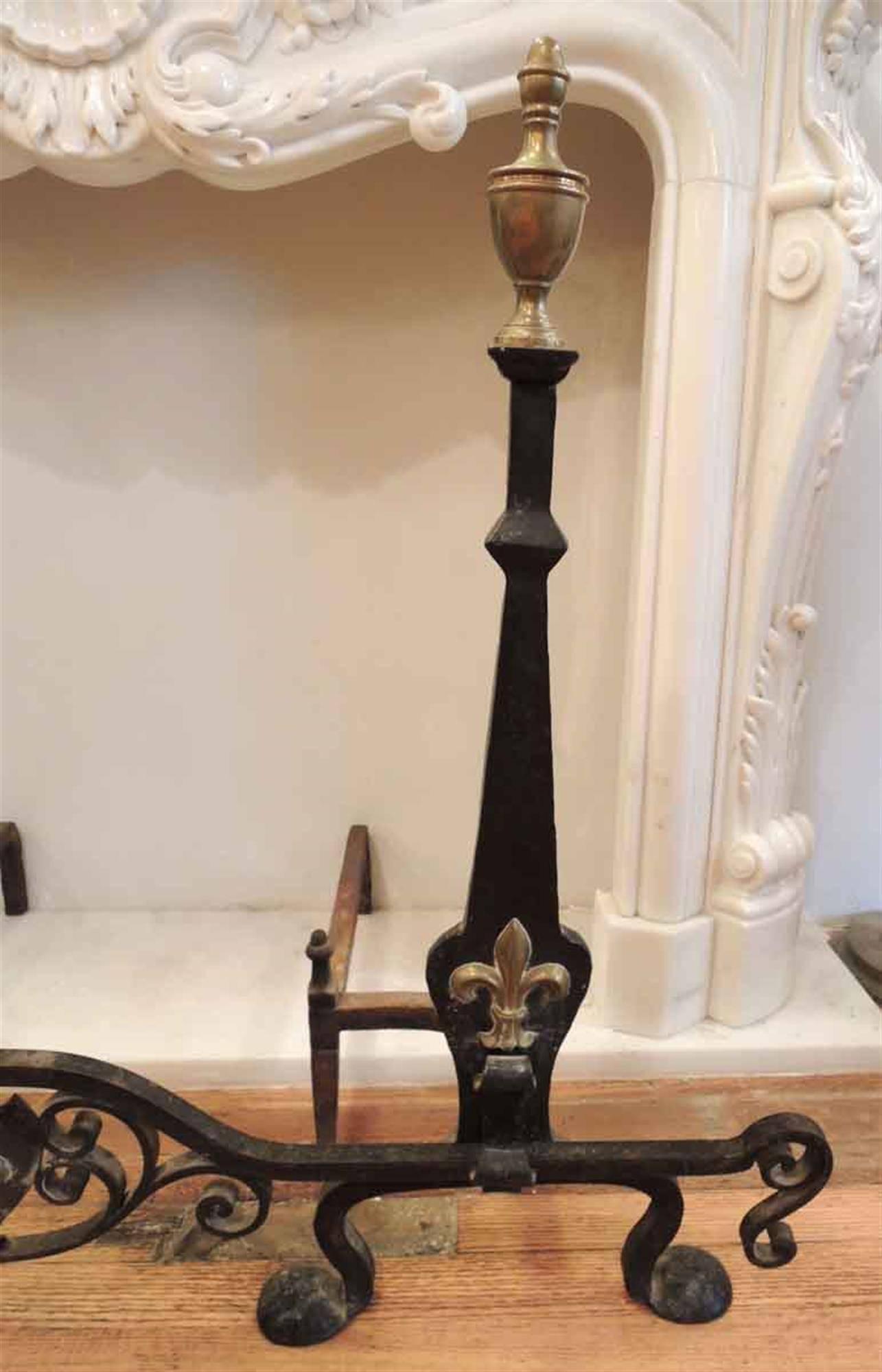 1910 wrought andiron set with bar with a Fleur de Lis pattern and brass accents. Please note, this item is located in one of our NYC locations.