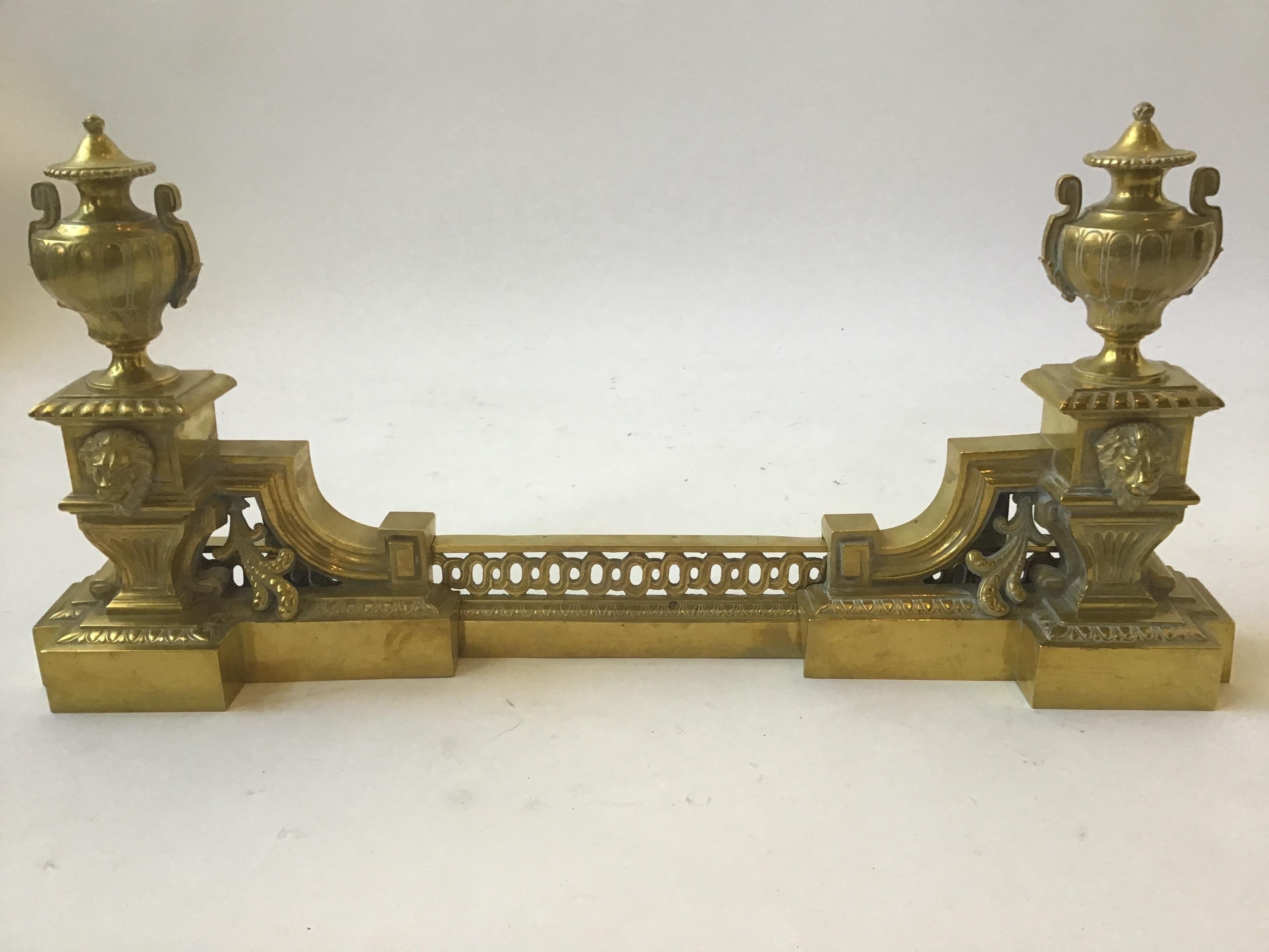 Turn of the century French brass fireplace fender adorned with lions and urns. Bar is adjustable to increase or decrease the width.