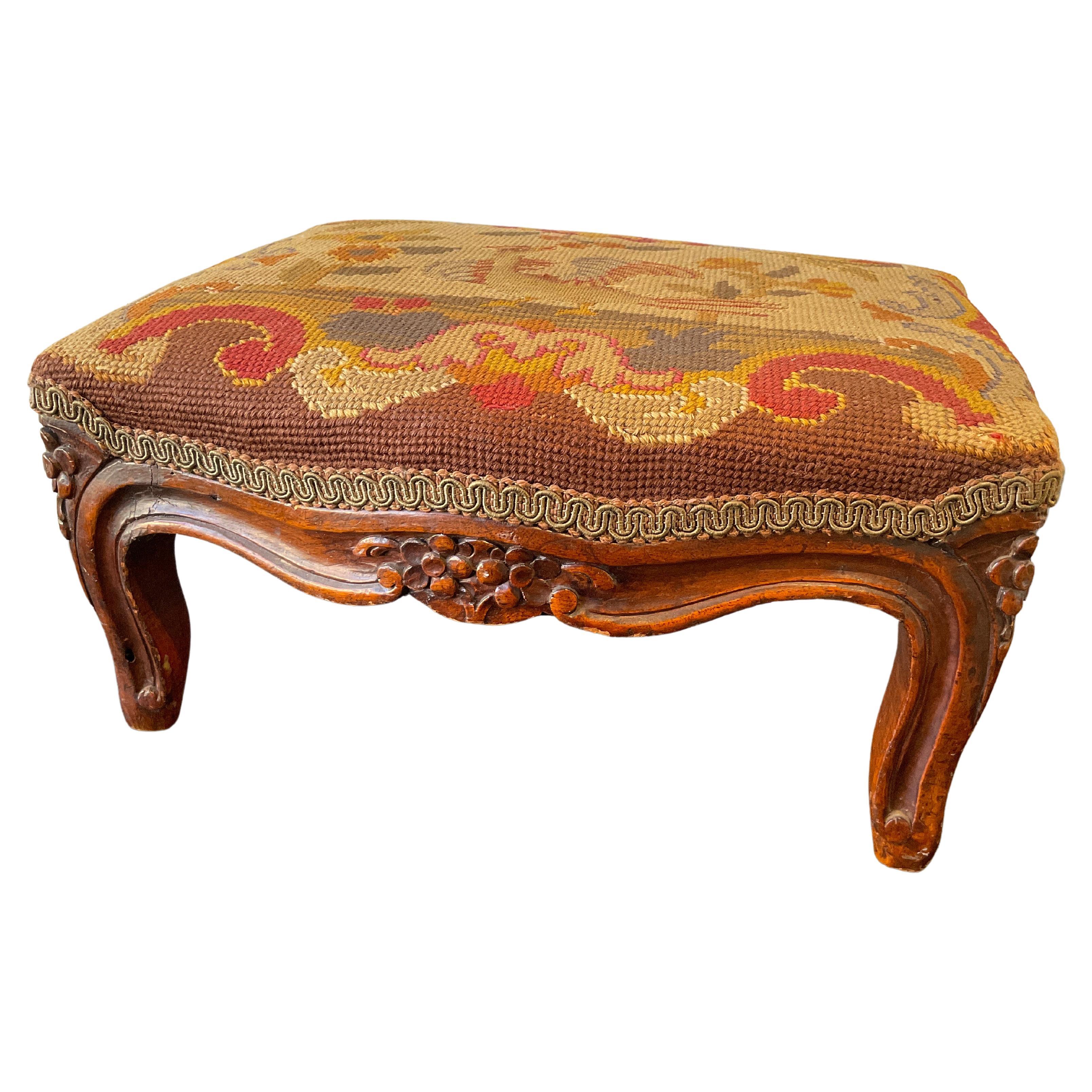 1910 French Hand Carved Wood Footstool with Needlepoint Top For Sale