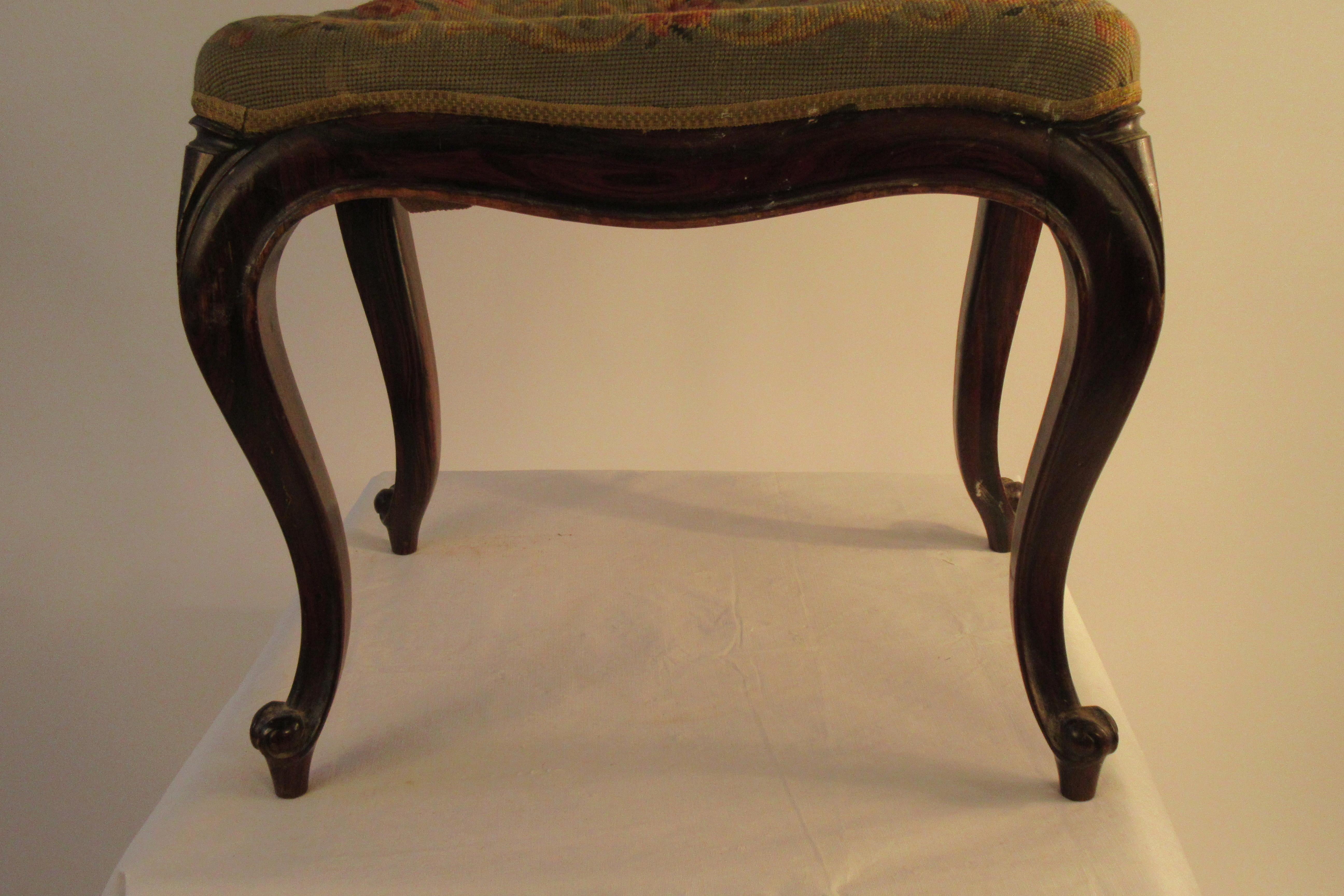 1910 French rosewood footstool with needlepoint seat. Seat needs to reupholstered.