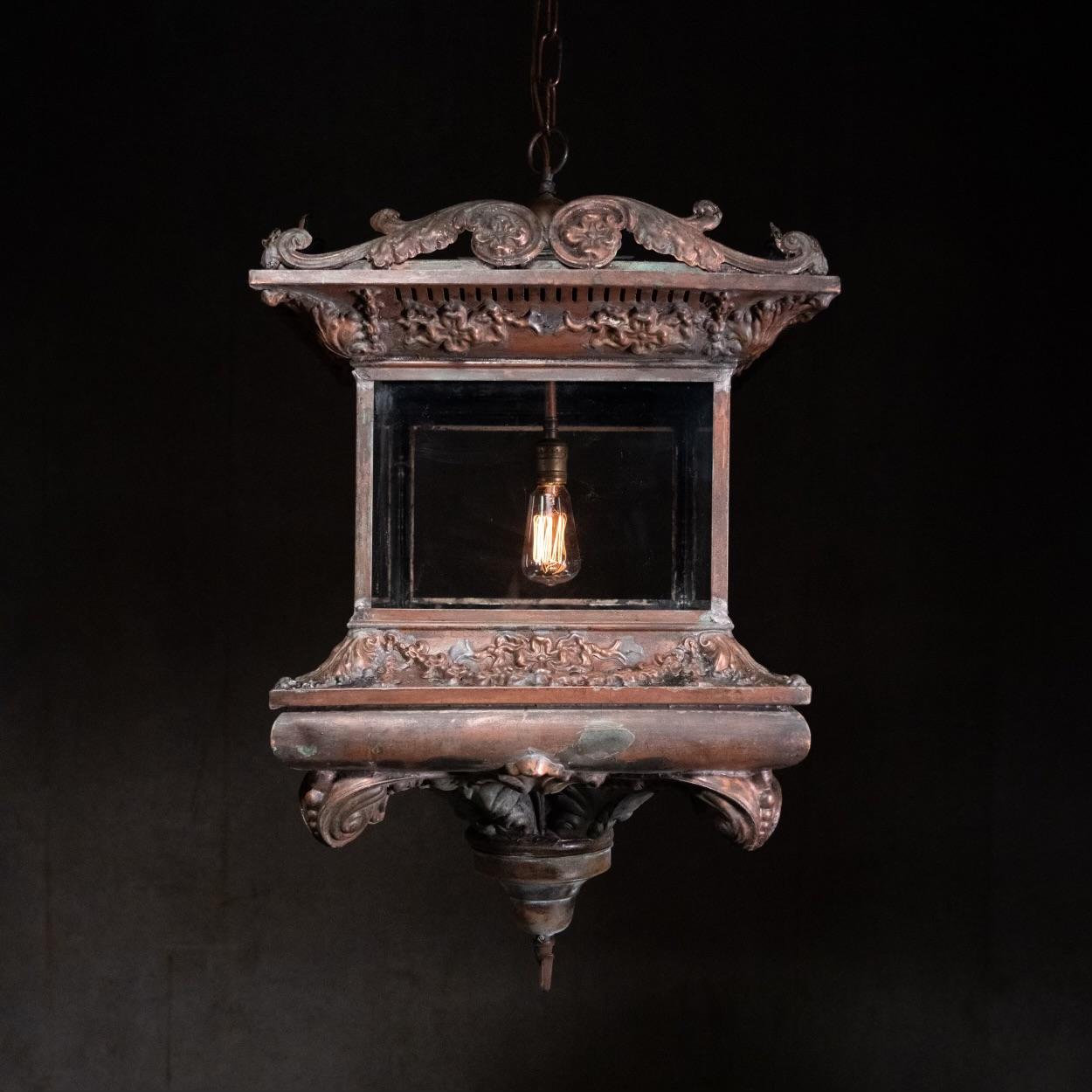 A pair of outstanding large lantern style pendants in embossed copper showing nice patina , detailed embossing , and a large impressive form.. these lights were found in the 1960's at a demolition  in NYC.. they are BTB French/Italian made and