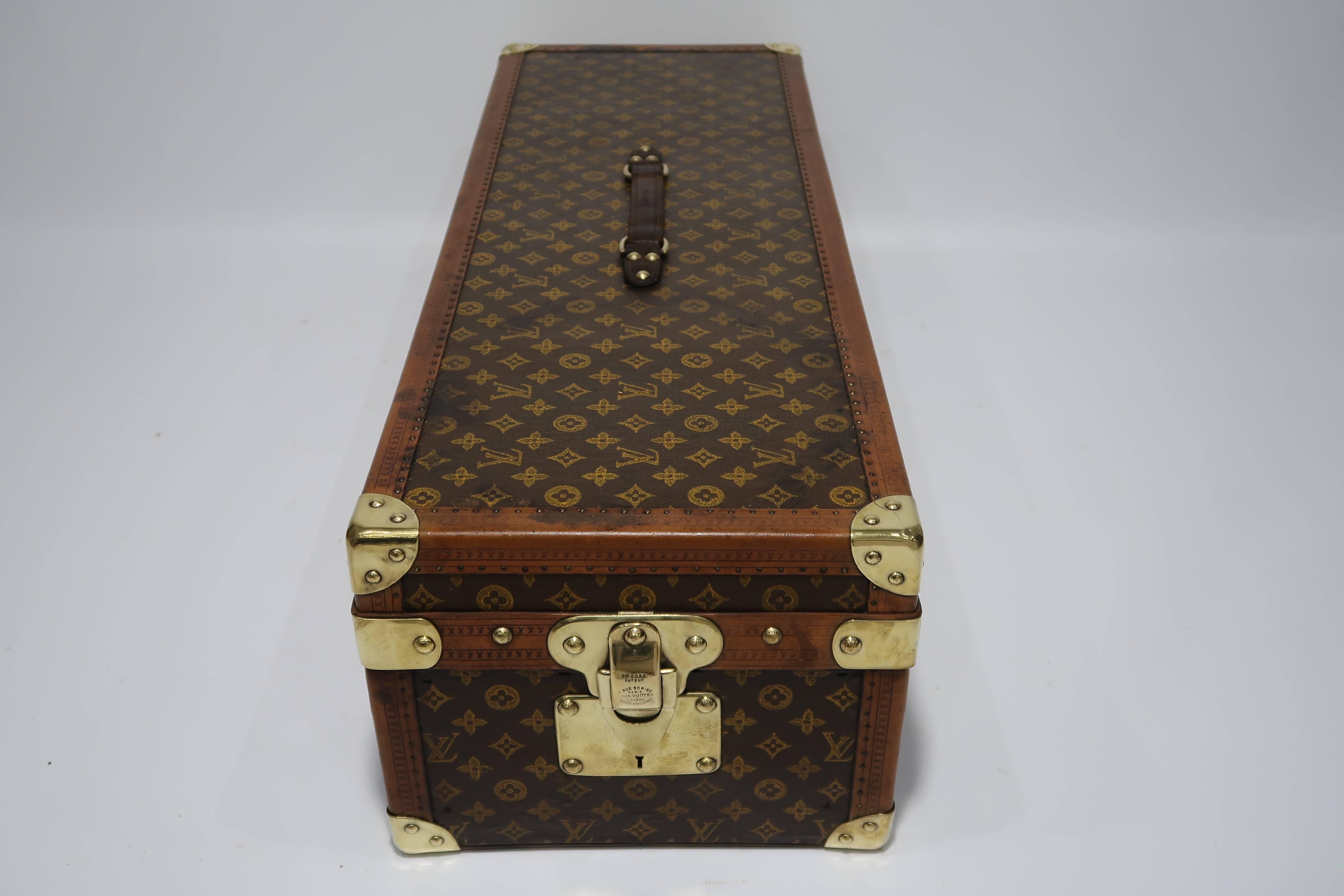 A Louis Vuitton Encyclopaedia Britannica library trunk, one of the 100 Legendary Trunks, made in 1910,
canvas case with LV monogram, lozine, brass rivets, locks, key and reinforced corners, leather handle, opening to reveal brown fabric lined