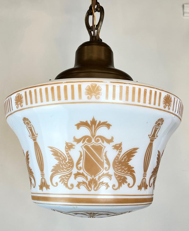 Very cool 1910 era Neo Classical pendant. The shade features crest. column and gryphon motif with acanthus accents. The original bronzed holder has has a lovely greek key motif border accented by cast chain links.  Rewired and CSA approved. 