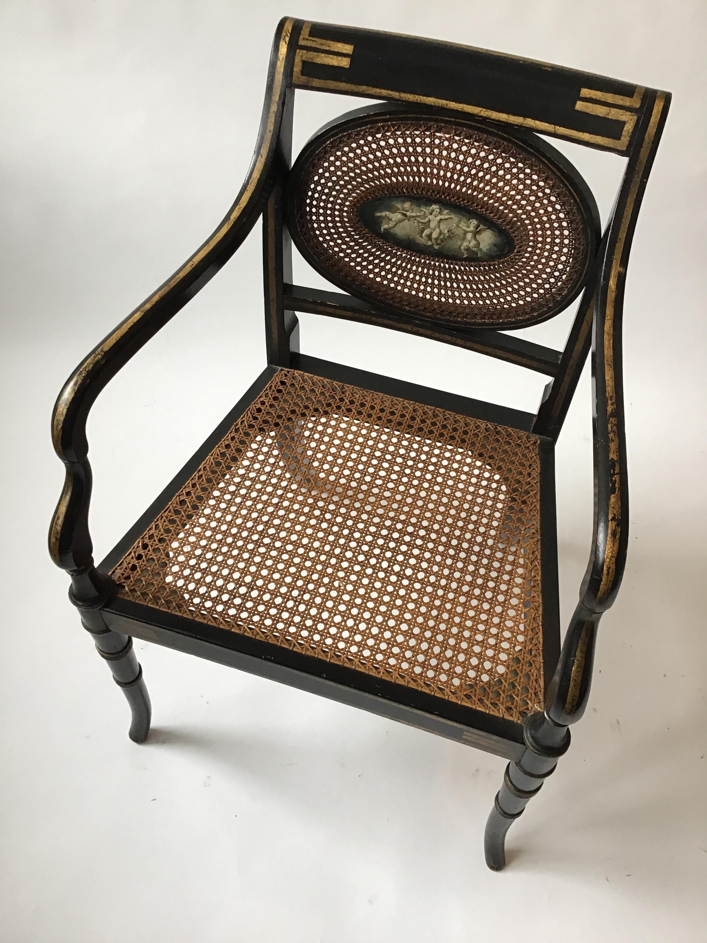 1910 Sheraton style hand caned armchair with hand painted cherub plaque.
