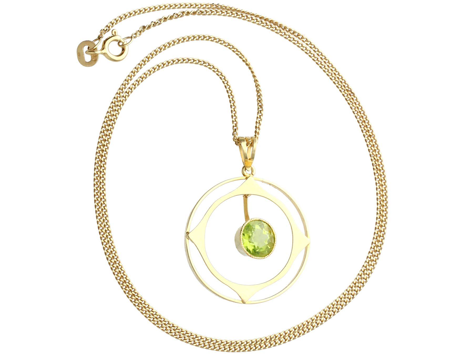 A fine and impressive antique 1.83 Carat peridot and 15k yellow gold pendant; part of our diverse antique jewelry and estate jewelry collections.

This fine and impressive antique pendant has been crafted in 15k yellow gold.

The pierced decorated,