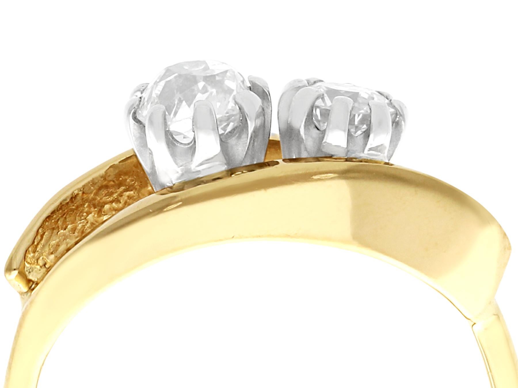 Two antique diamonds displayed in a contemporary 18 karat yellow gold setting; part of our diamond jewellery and estate jewelry collections.

This impressive two stone ring has been crafted in 18k yellow gold.

The contemporary pierced decorated