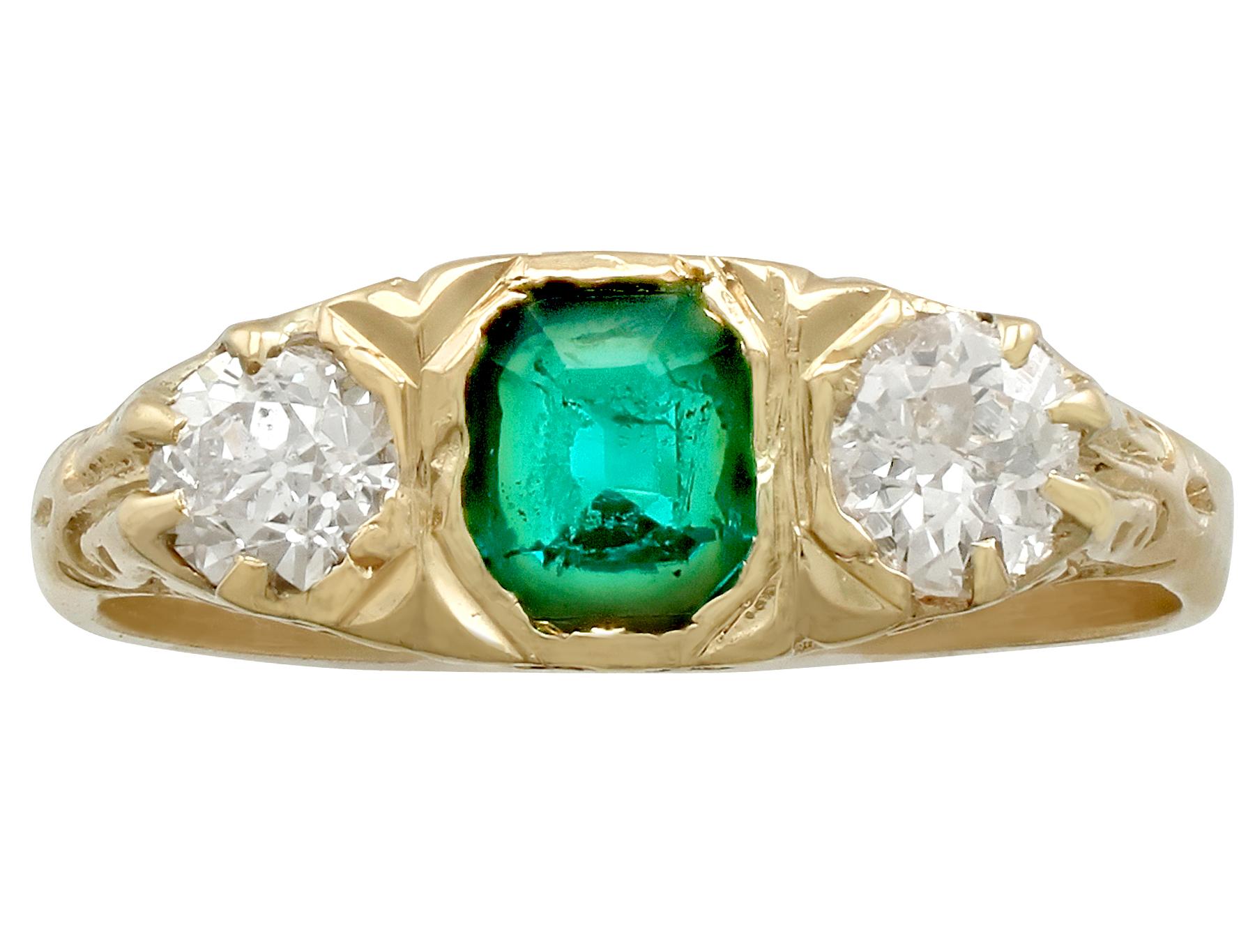 A fine and impressive antique 0.44 carat natural emerald and 0.42 carat diamond, 18 karat yellow gold, three stone ring; part of our antique jewelry and estate jewelry collections.

This impressive antique dress ring has been crafted in 18 karat