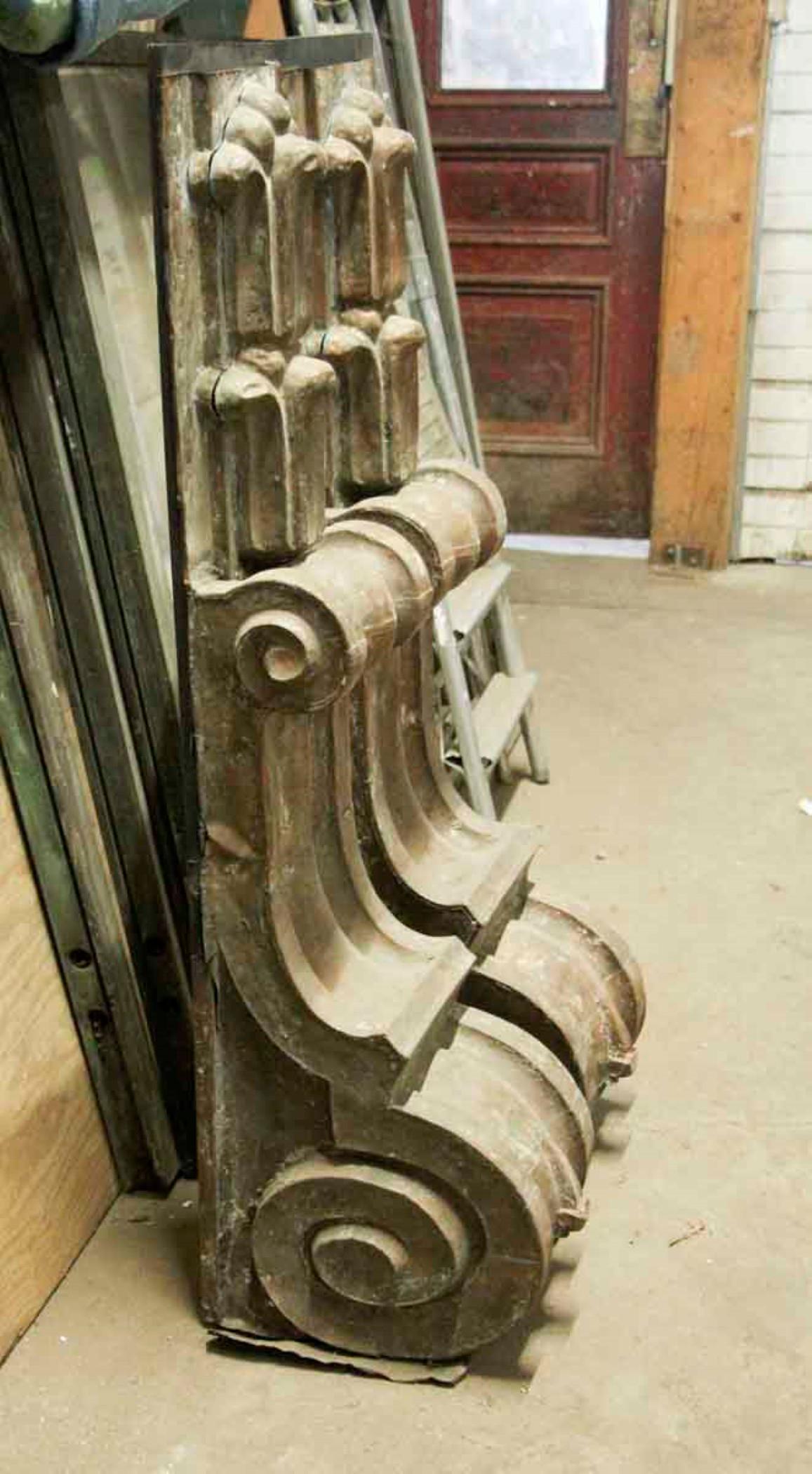 This pair of antique copper corbels is the work of an early 20th century craftsman. They are large scale, and measure just over 4 feet high. They have a natural patina from the outside elements, where they were displayed near the windows of a