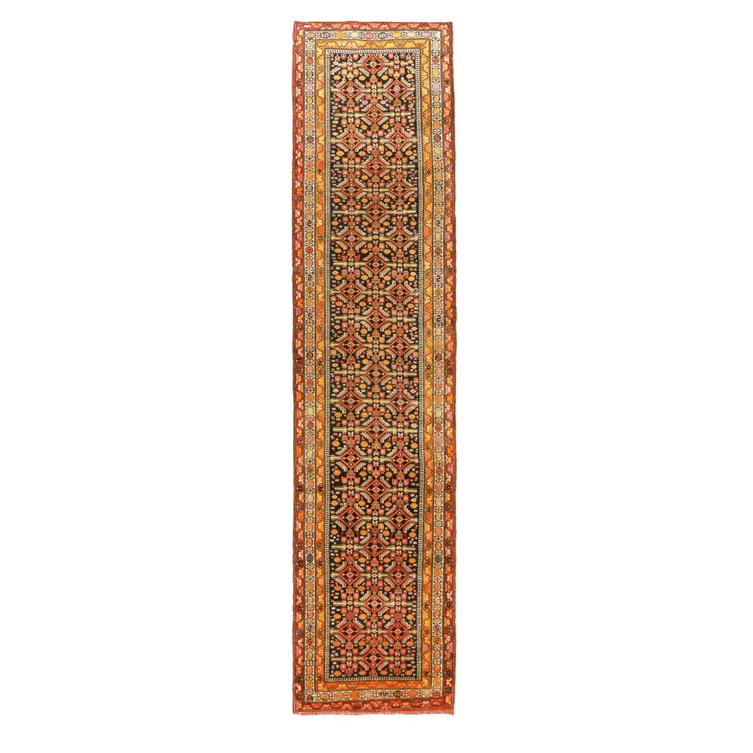 Handwoven from the finest wool, this antique Persian rug features fine floral designs infused with ornate geometric patterns familiar with many Azerbaijan carpets. It has a navy blue background mixed with orange, red and pink hues to showcase all