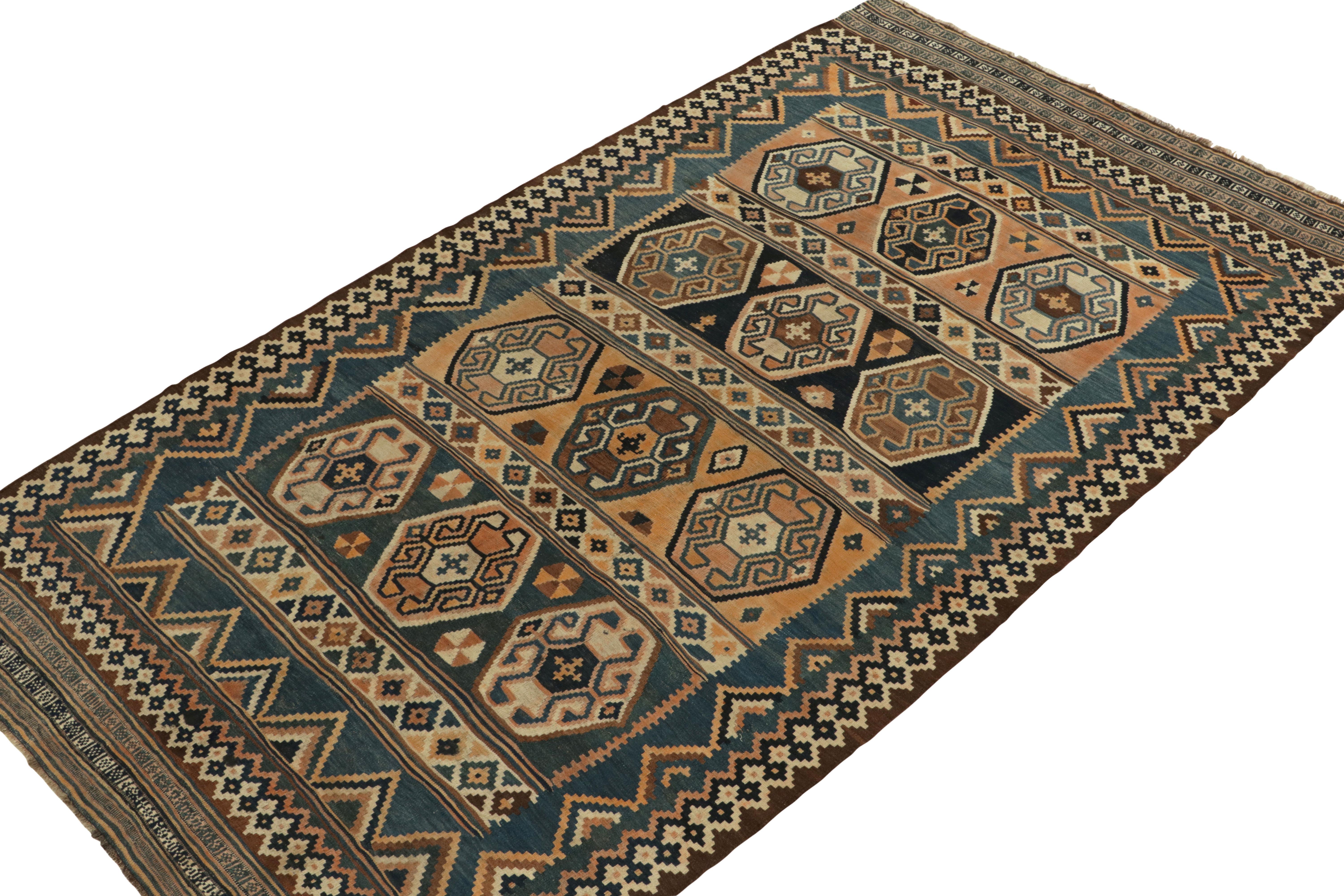 Hailing from Russia circa 1910-1920, an antique Kuba kilim rug - now joining Rug & Kilim’s classic selections. 

This exemplary Caucasian flat weave revels in handsome variation of tones of blue, brown & beige in the gul motifs & allied geometric