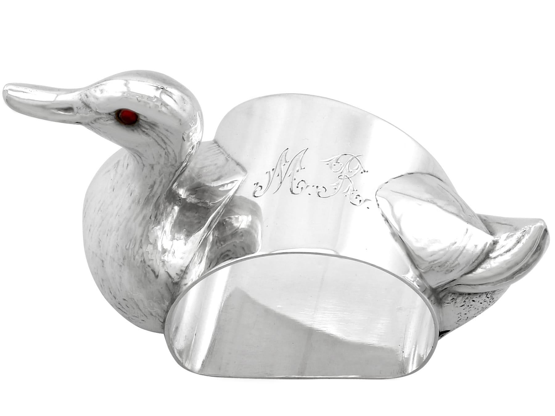 An exceptional, fine and impressive antique George V English sterling silver duck napkin ring; an addition to our christening silverware collection.

This exceptional antique George V sterling silver napkin ring has been realistically modeled in