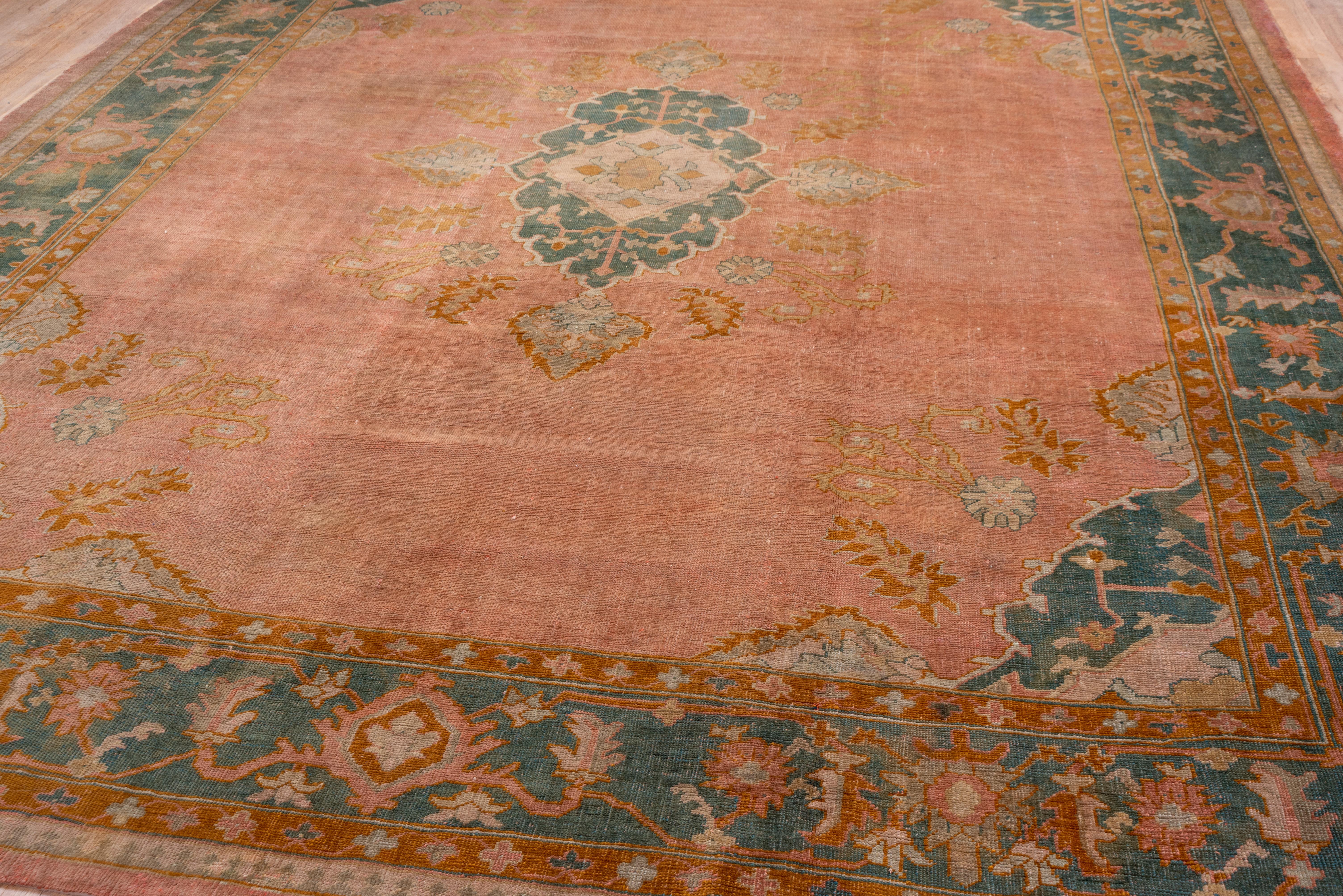 1910s Antique Turkish Oushak Rug, Pink FIeld, Dark Green & Orange Borders In Good Condition For Sale In New York, NY