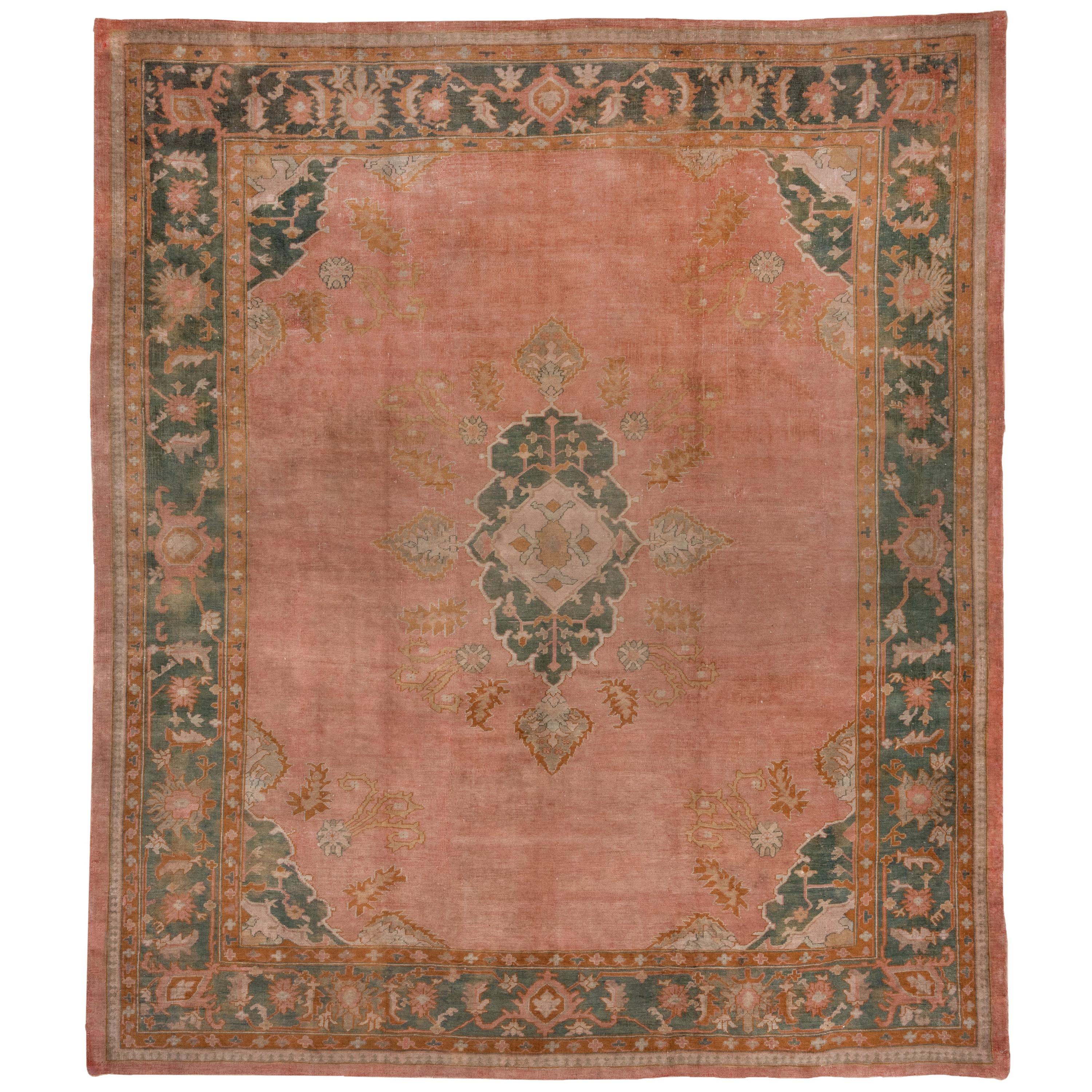 1910s Antique Turkish Oushak Rug, Pink FIeld, Dark Green & Orange Borders For Sale