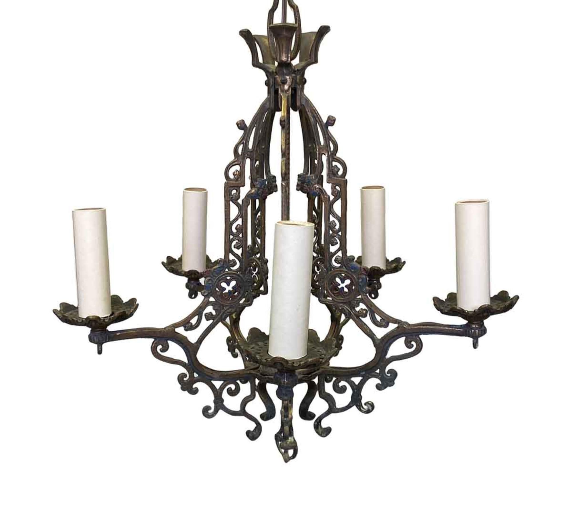1910s heavy cast bronze five-arm Arts & Crafts chandelier with a deep patina and painted details. This can be seen at our 400 Gilligan St location in Scranton, PA.