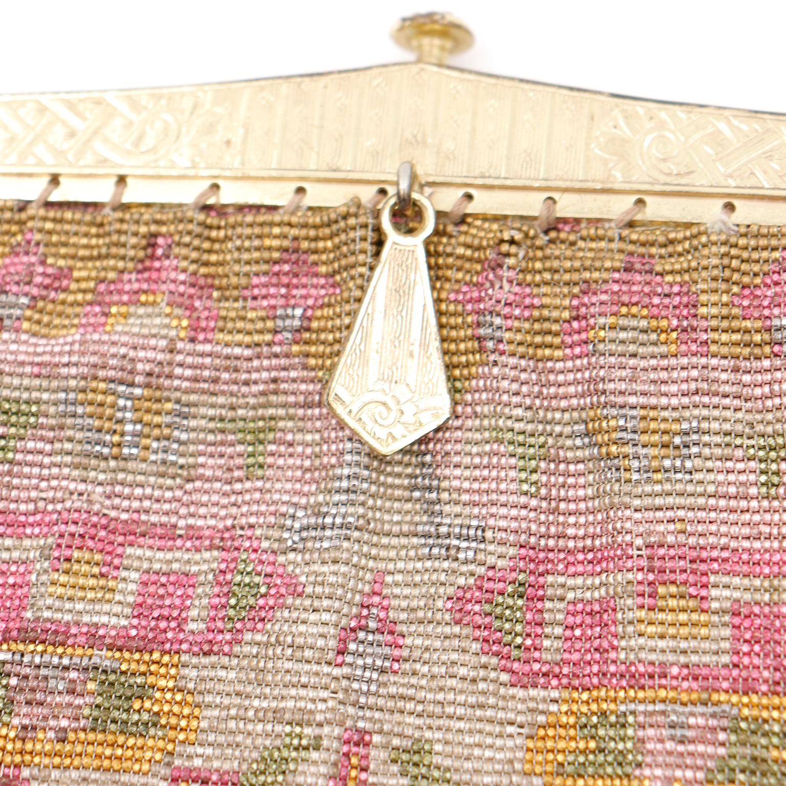 This 1910's antique handbag is such a beautiful example of a higher end finely beaded bag from that time period! This exquisite Edwardian evening bag is fully micro beaded with French cut steel beads in shades of gold, ivory, green and pink. The
