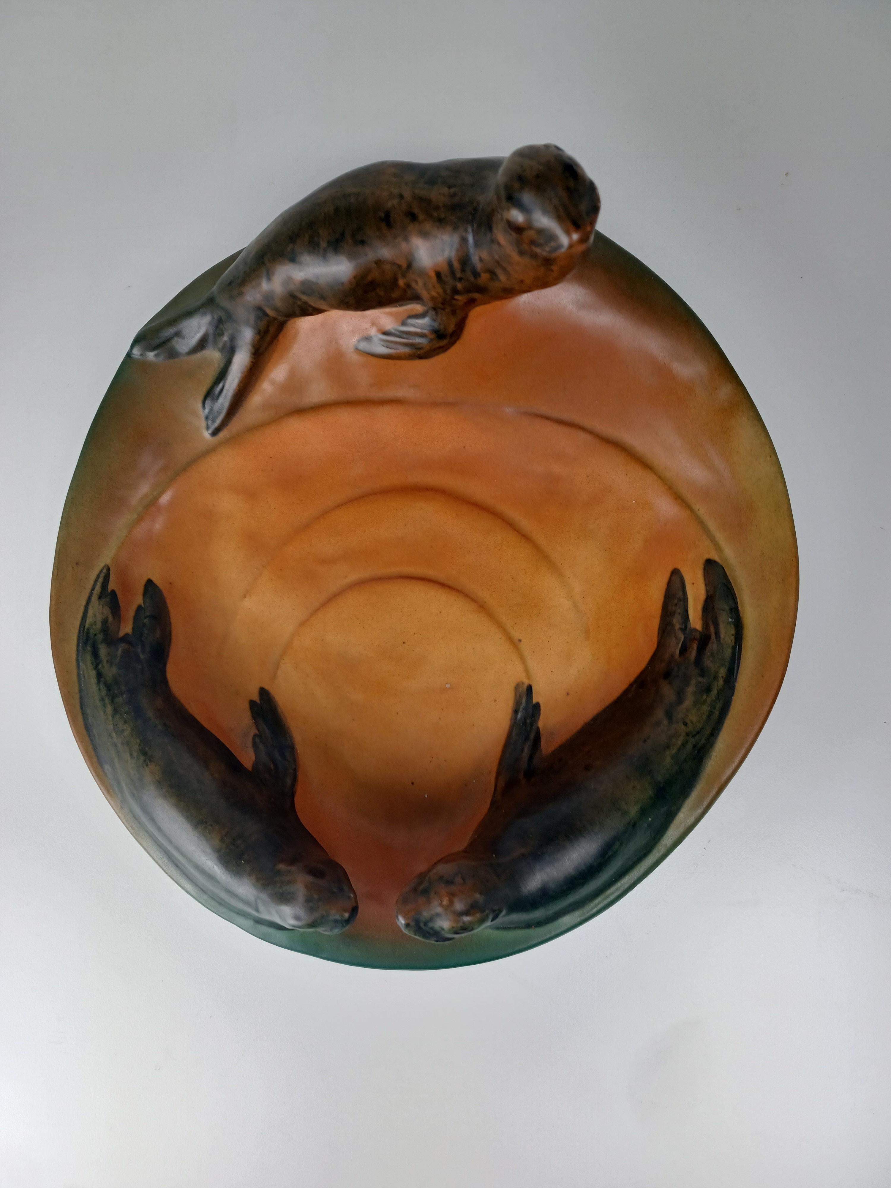 1910's Danish art nouveau handcrafted sealion bowl - ash tray by P. Ipsens Enke

The handcrafted art nuveau bowl featureing sealions designed in 1915 by Miss Nesnée is in very good condition condition.

Ipsens Enke (1843 - 1955) was a very