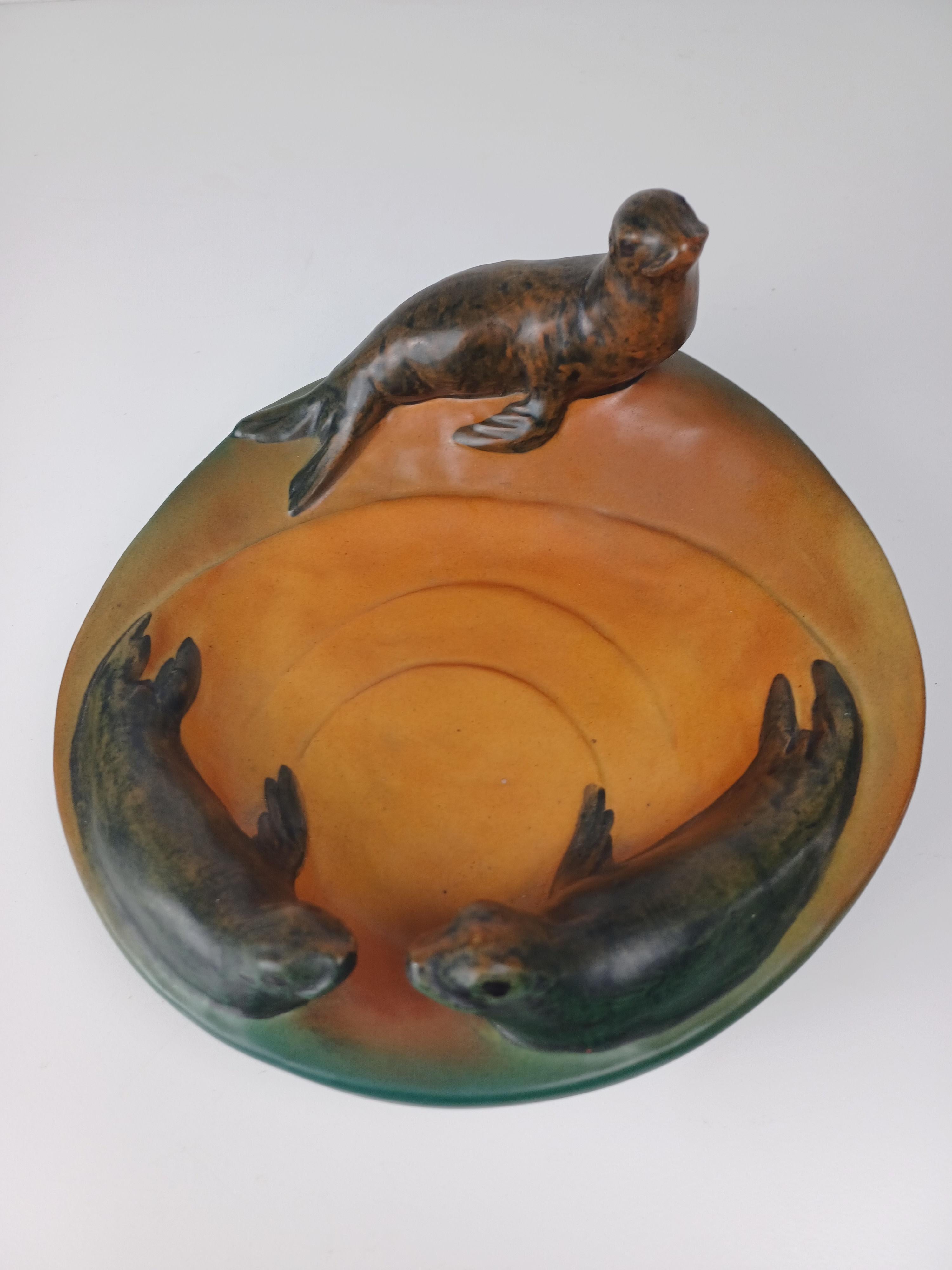 1910's Danish art nouveau handcrafted sealion bowl - ash tray by P. Ipsens Enke

The handcrafted art nuveau bowl featureing sealions designed in 1915 by Miss Nesnée is in good tage vintage condition condition.

Ipsens Enke (1843 - 1955) was a very