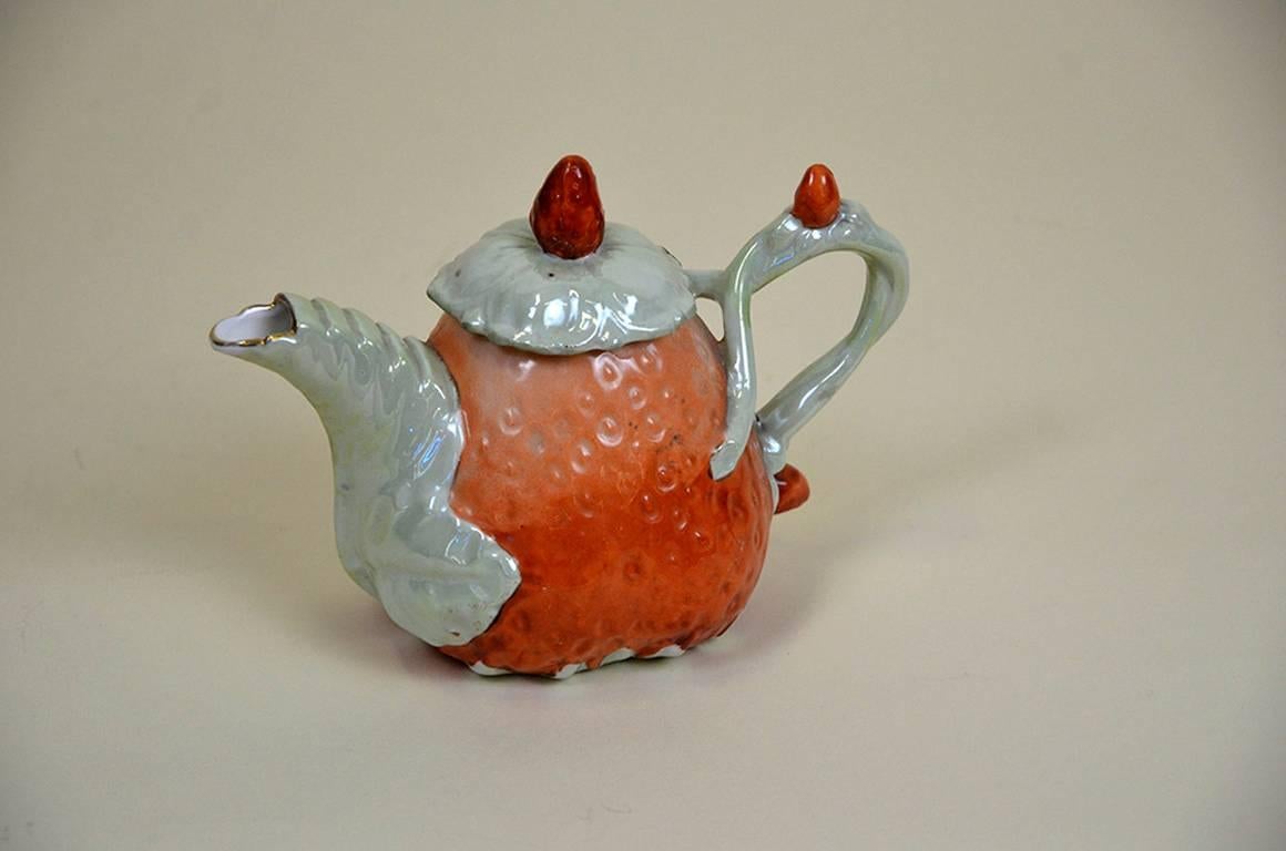 Edwardian porcelain strawberry shaped teapot, made in England with a small strawberry on top of the lid.

