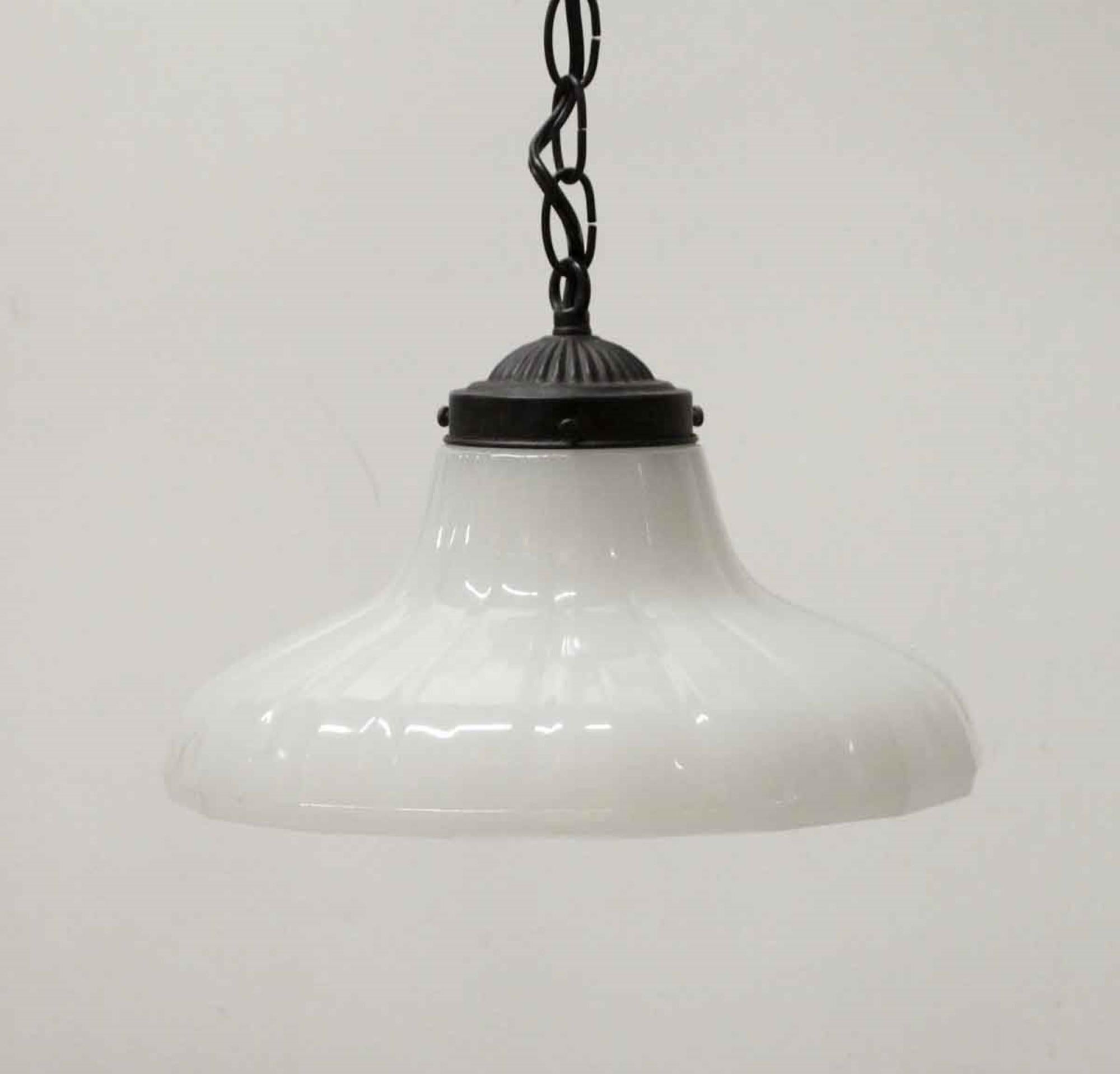 White fluted 1910s milk tapered glass shade on a newly wired blackened brass chain fixture, chain and canopy. Price includes restoration. Cleaned and rewired. Small quantity available at time of posting. Priced each. Please inquire. Please note,