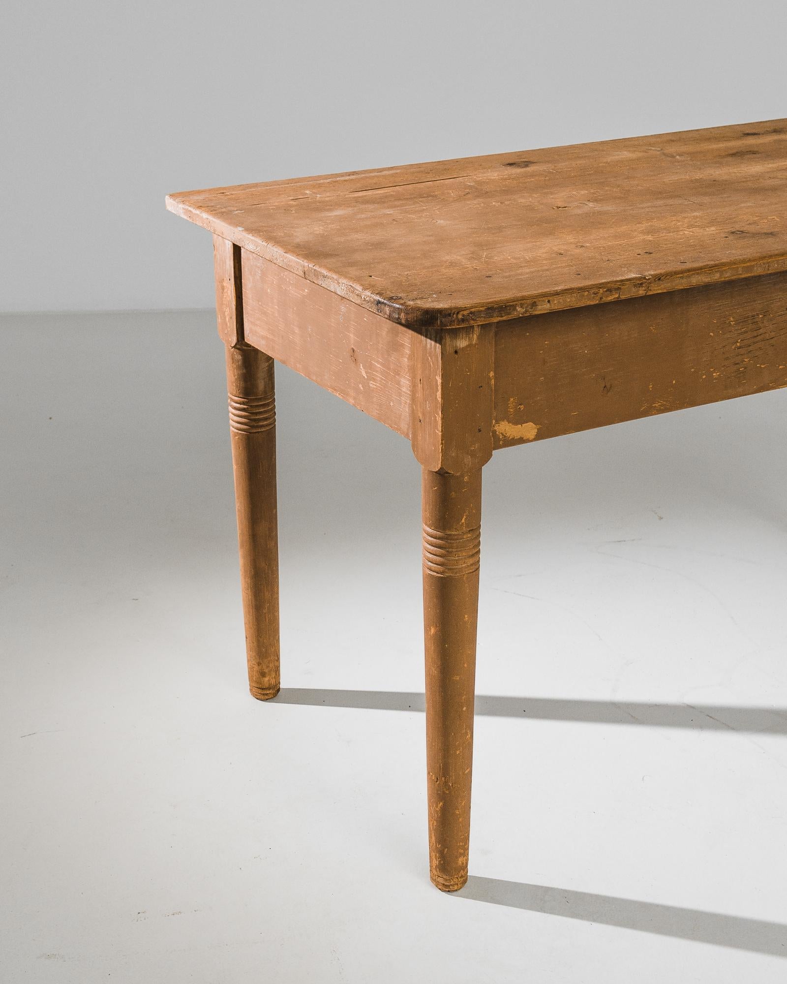 Stepping into the elegant ambiance of early 20th-century France, this patinated wooden table from the 1910s exudes a sense of timeless charm and sophistication. Crafted with meticulous attention to detail, this table epitomizes the craftsmanship and