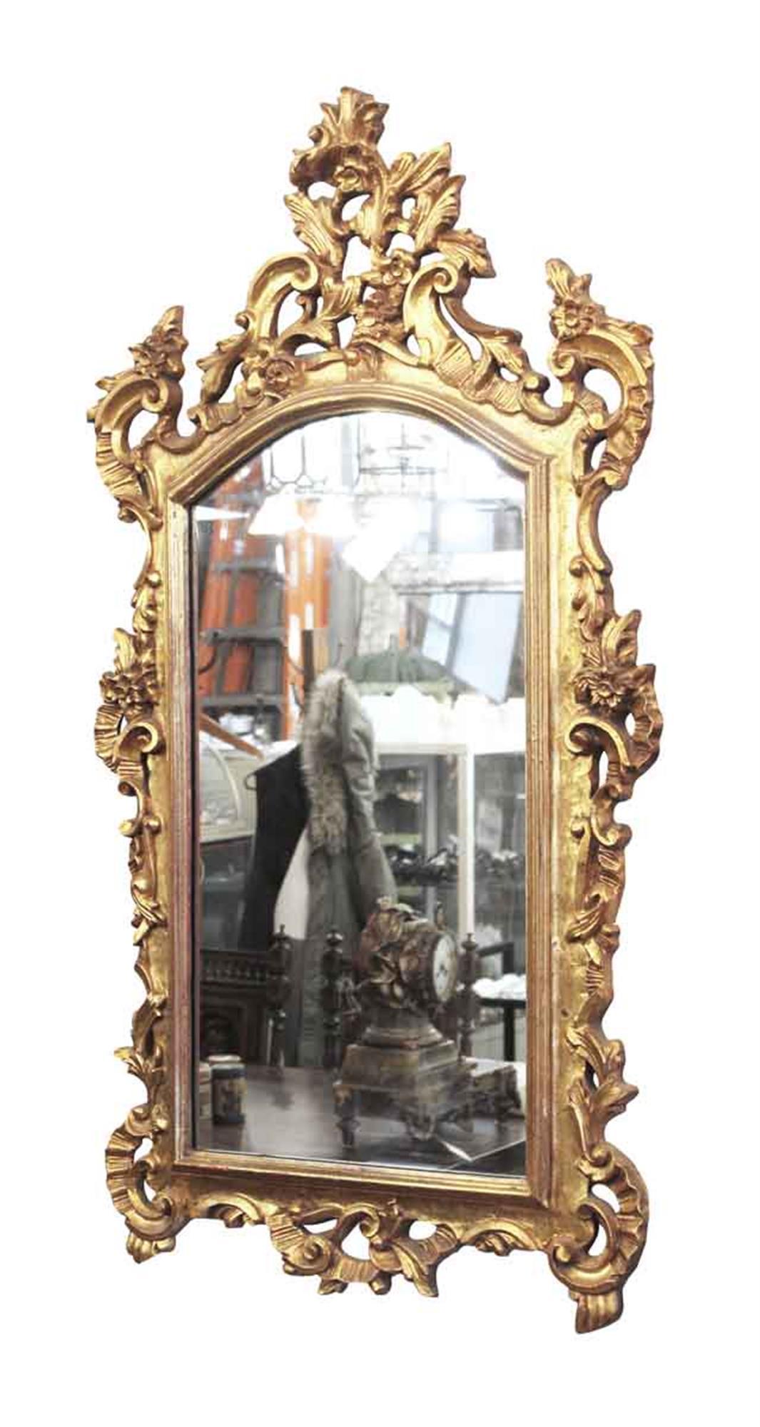 Gold giltwood highly ornate carved wall mount mirror. French 1910s. This can be seen at our 2420 Broadway location on the upper west side in Manhattan.