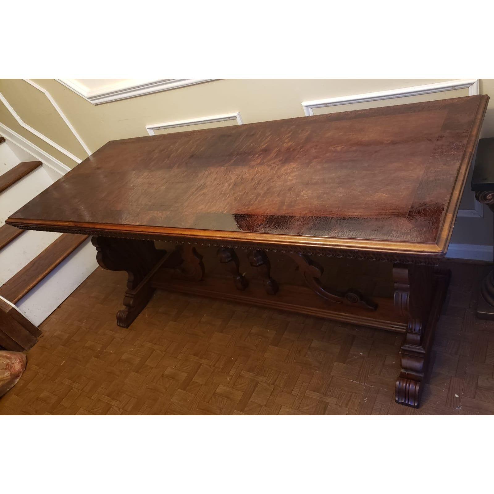 Very Rare 1910s Imperial Grand Rapids trestle table in fine carved walnut wood. Top made out of Banded and bookmatched dark walnut veneer. Table has been refinished and is in great condition. This table was first commissioned for the Central United