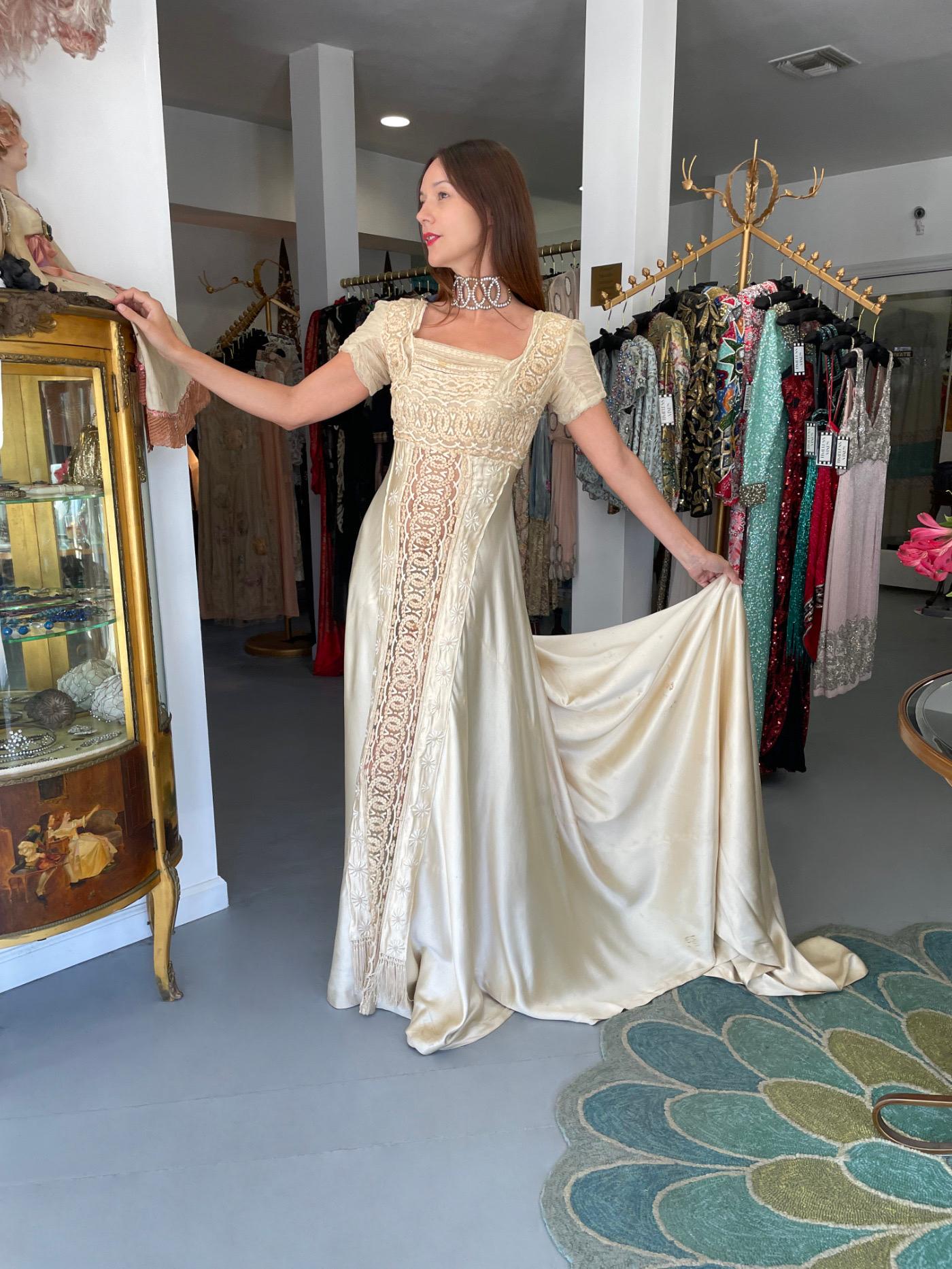 Les robes de mariée éthérées du début du 20e siècle sont des favorites éternelles et celle-ci est une pièce maîtresse du mariage. Le style sans effort de ce vêtement est si moderne ; les broderies à la main complexes et les tissus fins sont un
