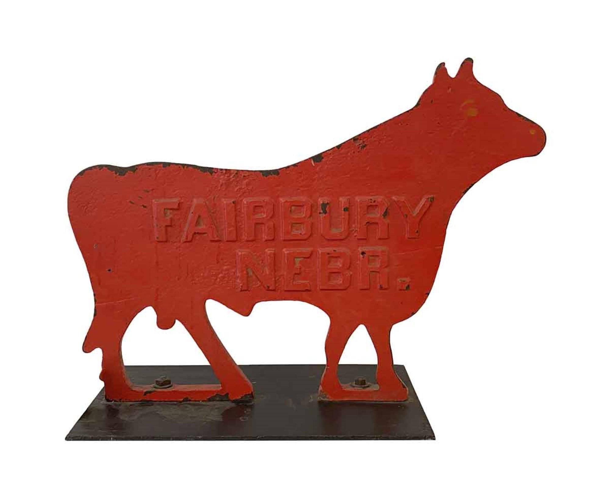 Heavy 1910s antique cast iron cow windmill counterbalance weight painted red. This may be the original paint as these were originally painted red so they could easily be seen against the sky to tell the wind's direction. Mounted on a new steel base.