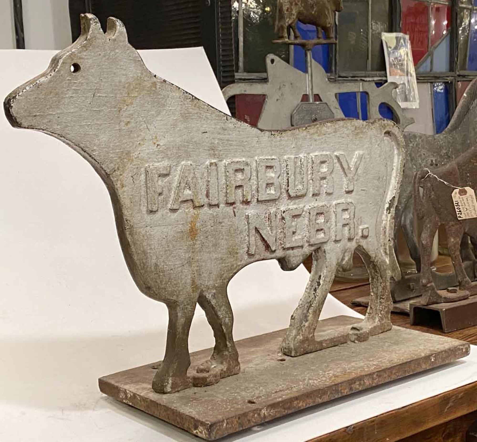 Heavy 1910s antique cast iron cow windmill counterbalance weight painted white. Mounted on the original base. Inscribed Fairbury Nebr. in raised lettering on both sides. These would pivot into the wind to show the wind's direction. Made by Fairbury