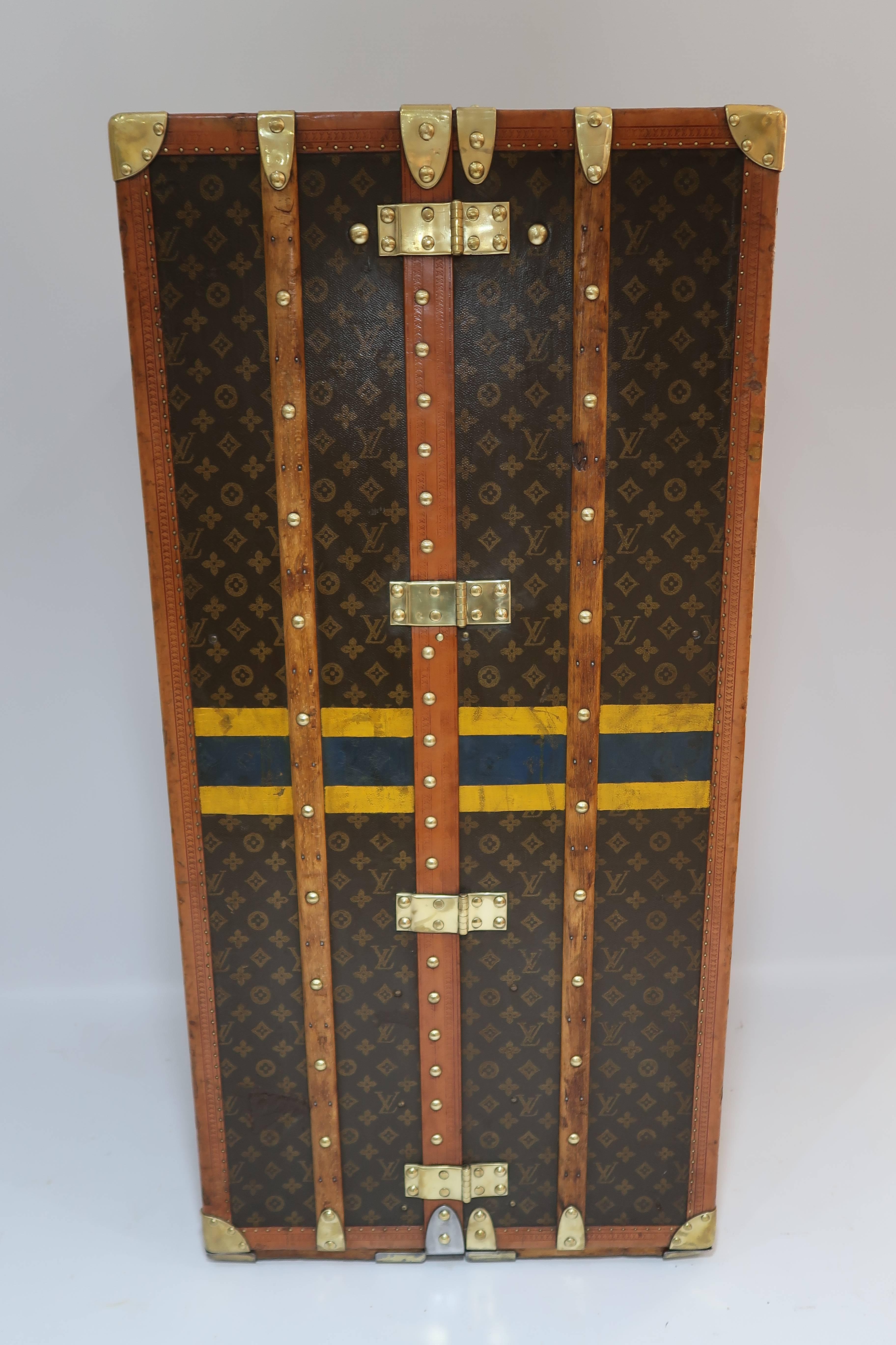 For sale a highly desirable antique wardrobe trunk by Louis Vuitton, with brass hardware, complete interior, monogram canvas, LV stamped lozine trim and stamped pins.

A collectible piece over 100 years old perfect for collectors or for decoration.