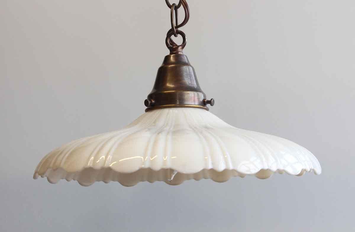 1910s scalloped rim white milk glass pendant light newly wired with new antique brass finish chain, canopy and fitter. Small quantity available at time of posting. Priced each. This can be seen at our 400 Gilligan St location in Scranton. PA.