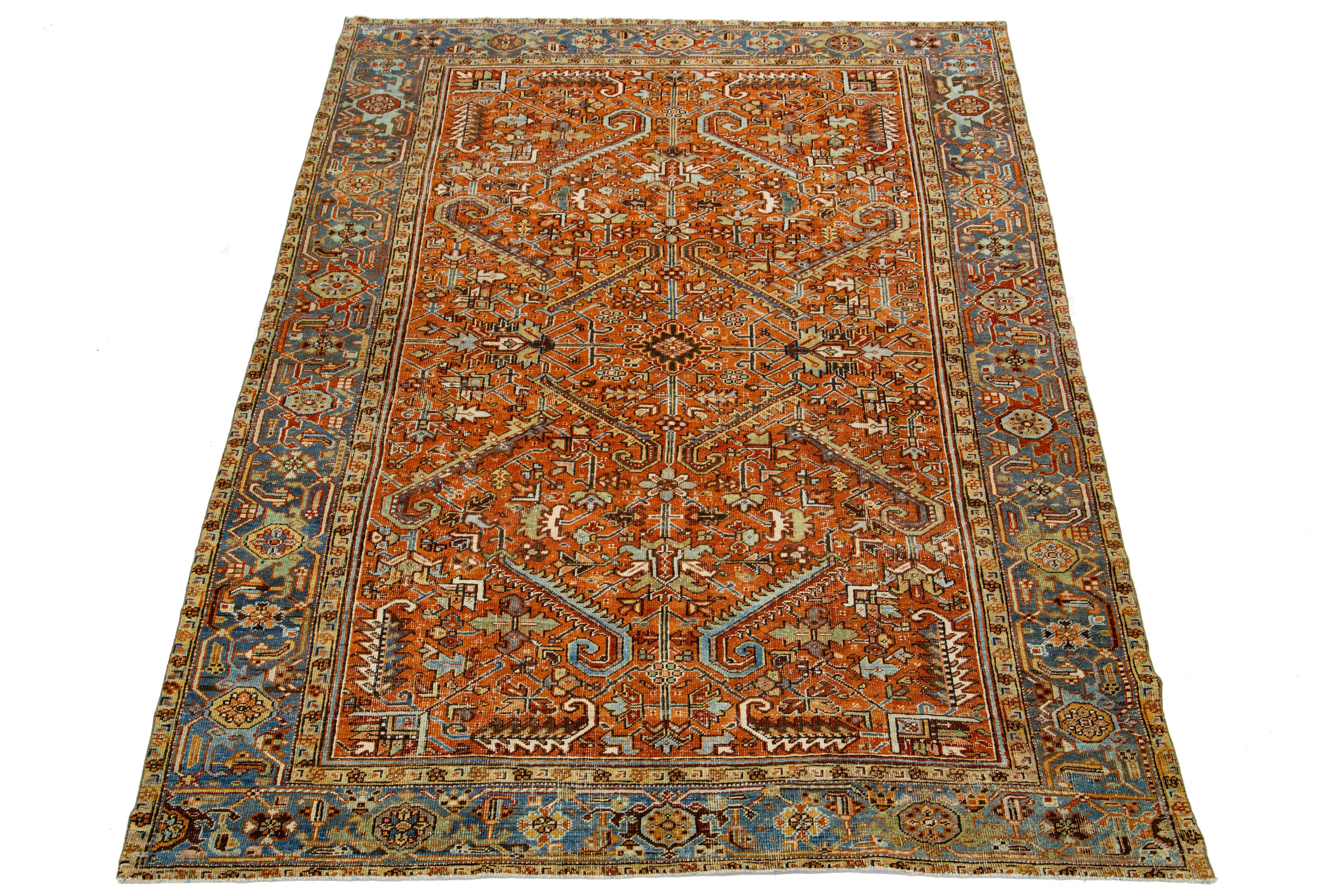 The antique Persian Heriz rug displays its impressive all-over design and hand-knotted wool construction. The soft beige field is a backdrop geometric floral pattern adorned in multicolor shades.

This rug measures 6'7