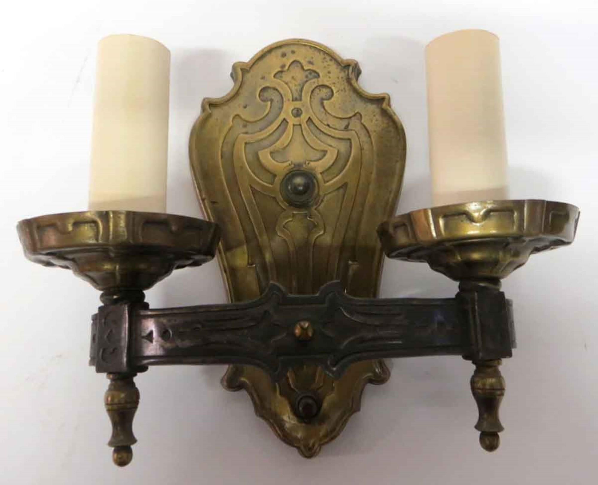 Pair of 1910s Art Nouveau brass wall sconces with two candlestick arms each. Priced as a pair. This can be seen at our 400 Gilligan St location in Scranton, PA.