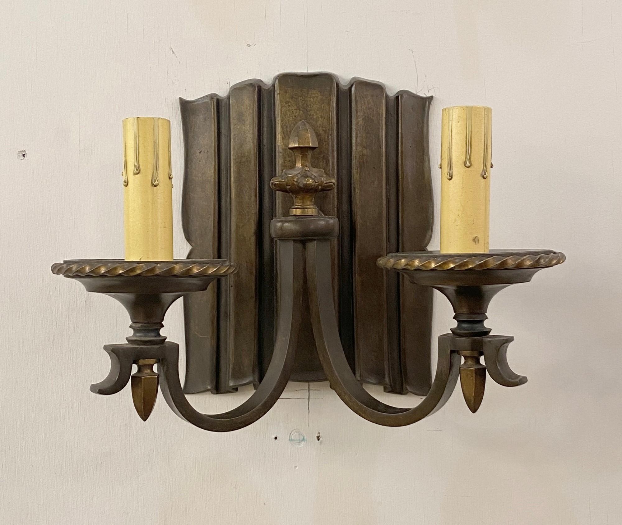 1910s pair of bronze Linenfold wall sconces in original dark patina finish. Each light has two lights. Cleaned and rewired. Sold as a pair. Please note, this item is located in one of our NYC locations.