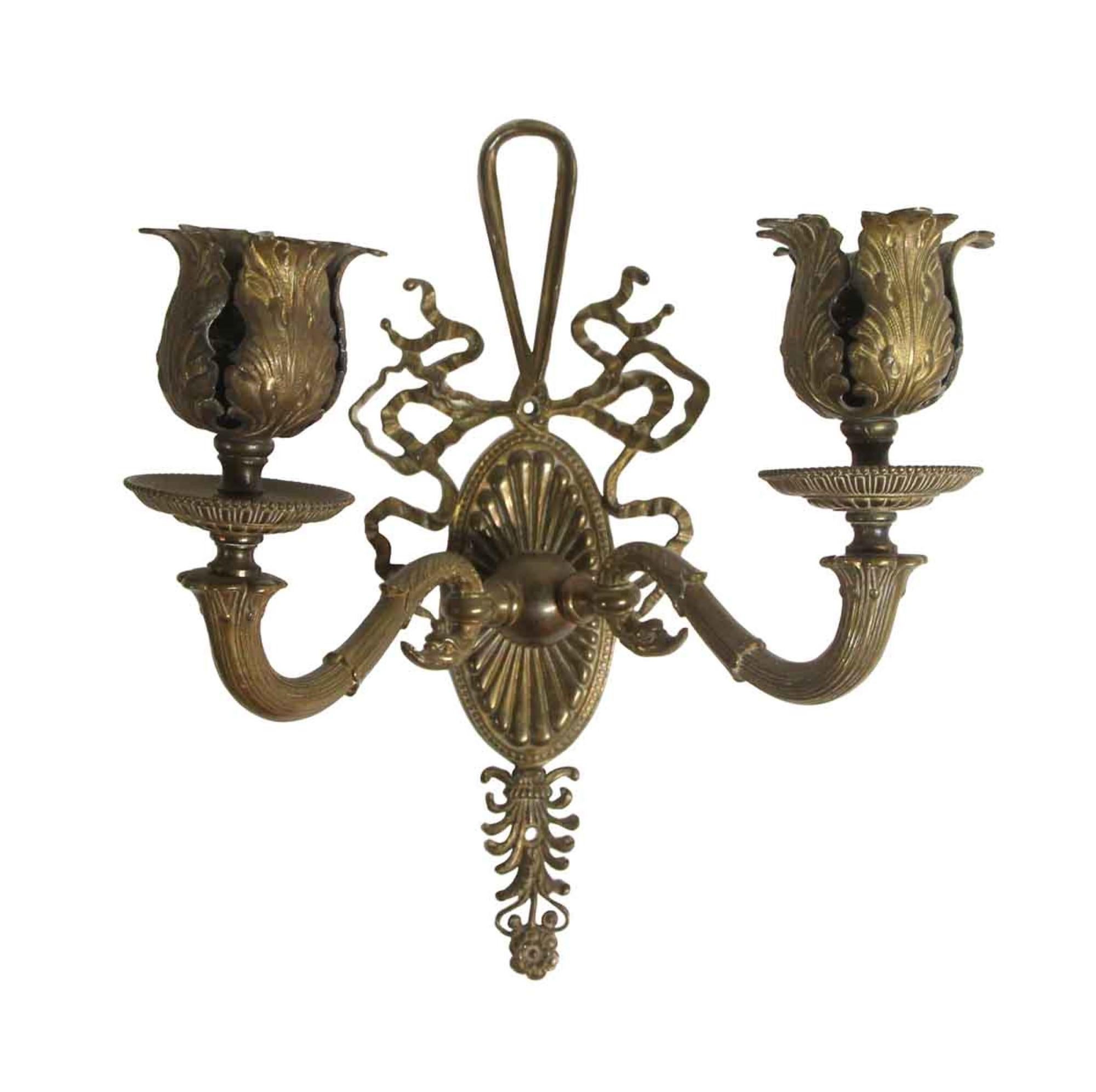 1910s pair of petite Federal style floral bronze sconces with two arms and ribbon detailing.. Priced as a pair. This can be seen at our 400 Gilligan St location in Scranton. PA.