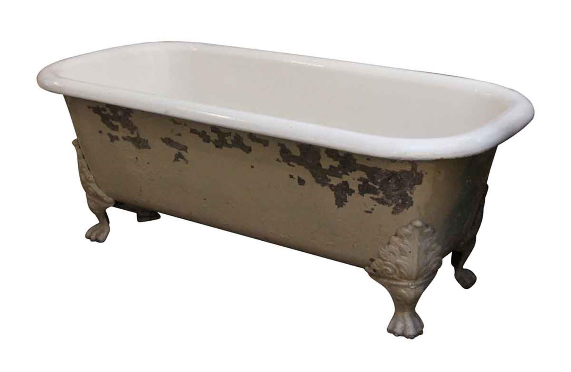 1930s painted white cast iron tub with centre drain and white claw feet. This is a rare find! There is some distress in the paint from age and use. This can be seen at our 5 East 16th St location on Union Square in Manhattan.