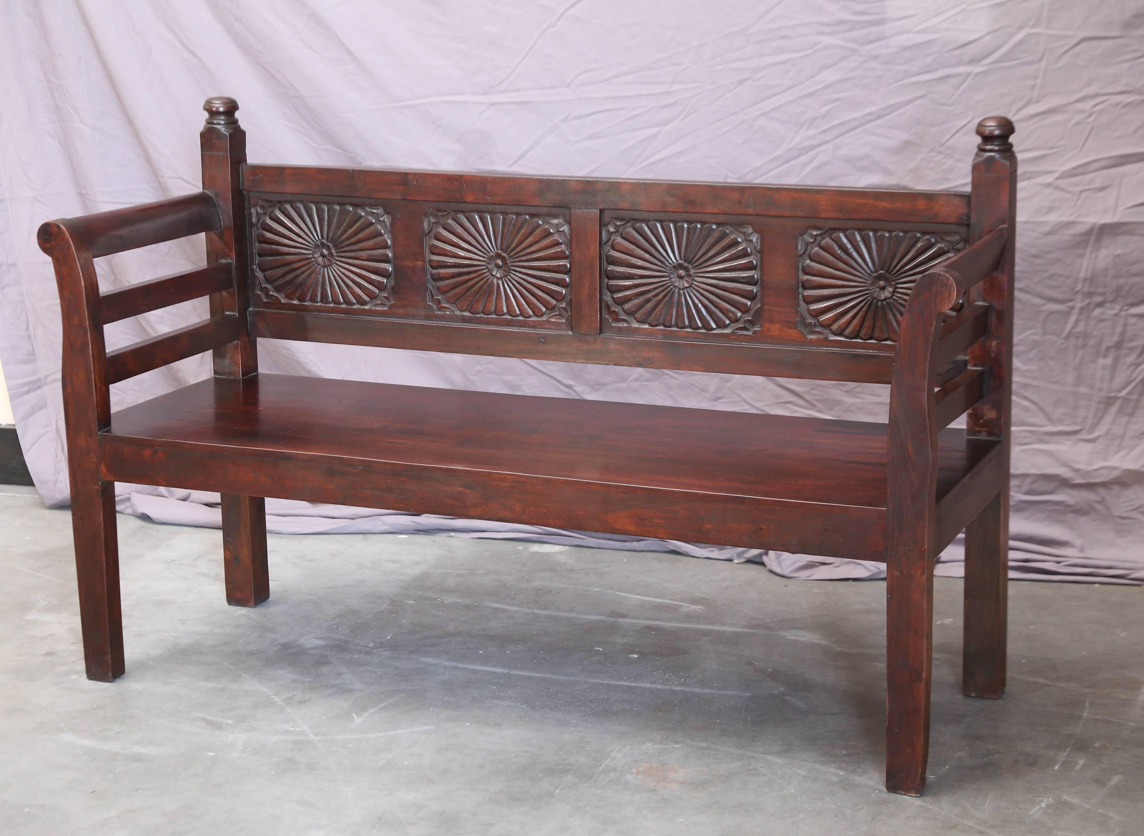 This beautifully crafted solid teak wood bench comes from a British Colonial home. Sunburst motif was supposed to bring sunshine and good fortune to a home. It is firm like a rock and is meant to last several generations. Crafted in old world